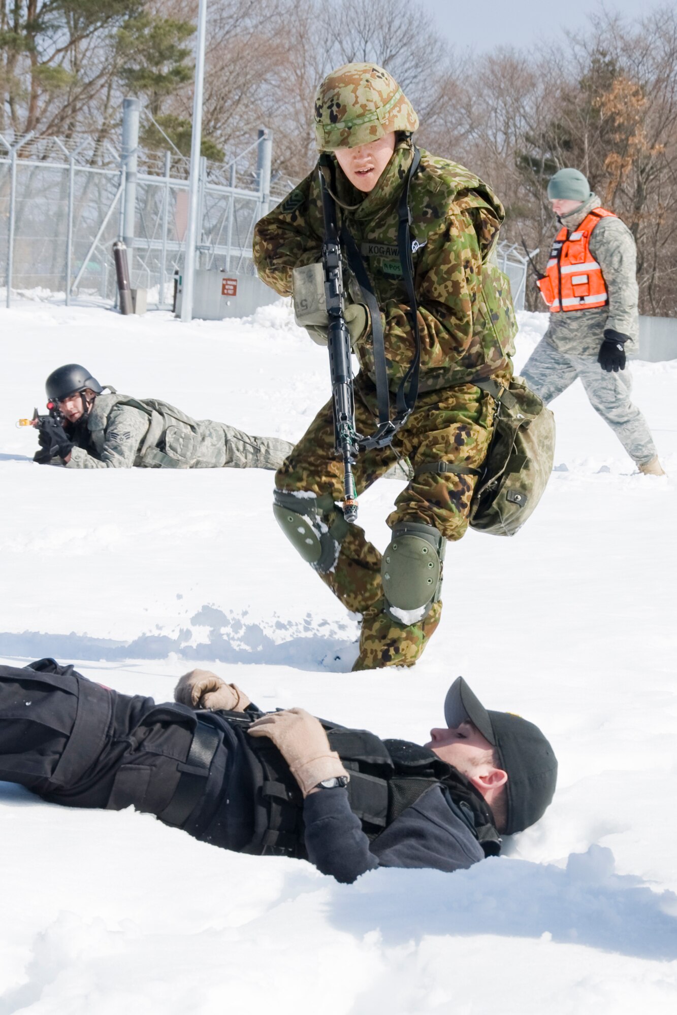 MISAWA AIR BASE, Japan -- Leading Private Shinji Kogawa, 2nd Company, 5th Infantry Regiment, Japan Ground Self-Defense Force, holds Staff Sgt. Daniel Oppman, 35th Security Forces Squadron standardization evaluator, at bay March 12 during Exercise Guard and Protect. During the exercise scenario, Sergeant Oppman played the role of an aggressor who attempted to gain unauthorized access to the area. (U.S. Air Force photo/Senior Airman Jamal D. Sutter)