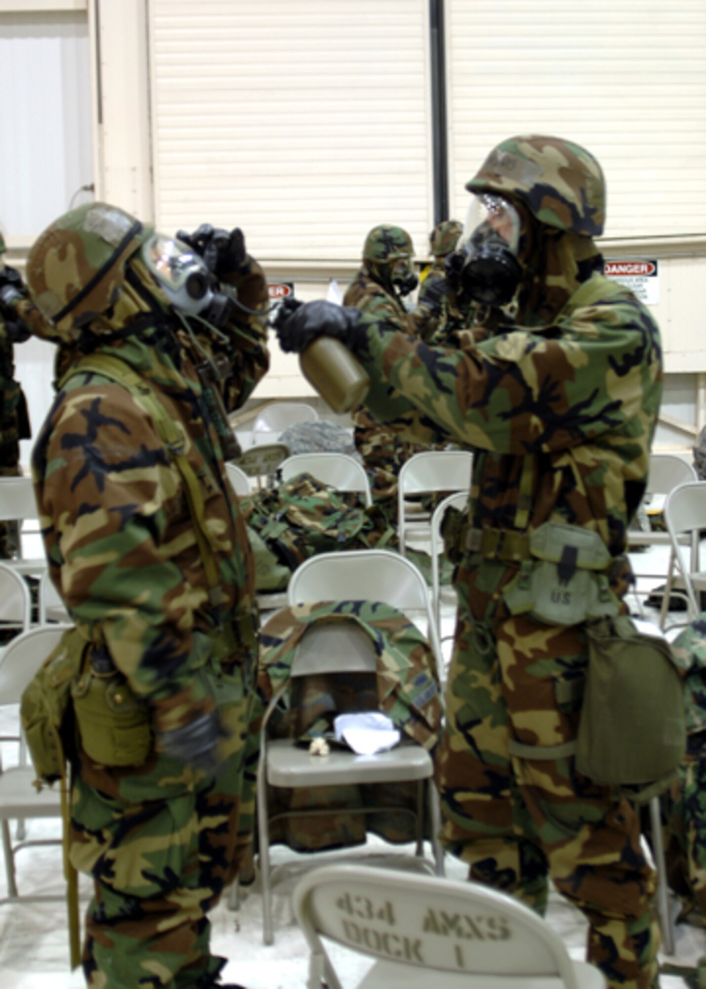 GRISSOM AIR RESERVE BASE, Ind. -- Tech. Sgt. John Pedro, 434th Maintenance Group quality assurance technician, and Tech. Sgt. Daniel Lewis, 434th MXG quality assurance technician, practice hydrating while in Mission Oriented Protective Posture level four, during an ability to survive and opertate exercise. (U.S. Air Force photo/Senior Airman Carl Berry)