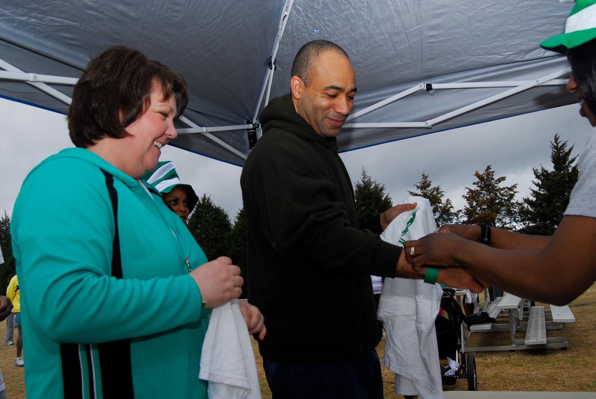 Mrs. Staci Johnson and Col. James Johnson, 43rd Airlift Wing, Commander, register for the Shamrock and Run here March 13. Pope Airmen and their families dance to Irish music at the 43rd Force Support Squadron's Shamrock and Run at the Fitness Center March 13. Participants ran a two-mile loop along the flightline. (U.S. AIr Force photo by 2nd Lt. Cammie Quinn)