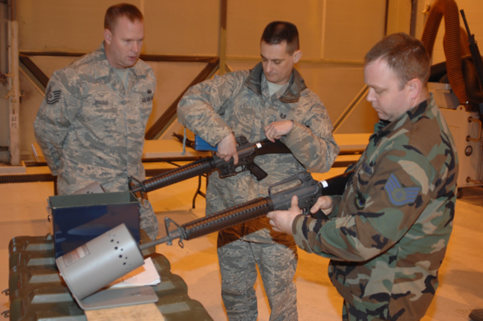 Tech. Sgt. Timothy Boggs, 434th Security Forces Squadron member, provides guidance to two members of the 434th Air Refueling Wing during a recent training session on how to properly clear an M-16.  (U.S. Air Force photo/Senior Airman Carl Berry)