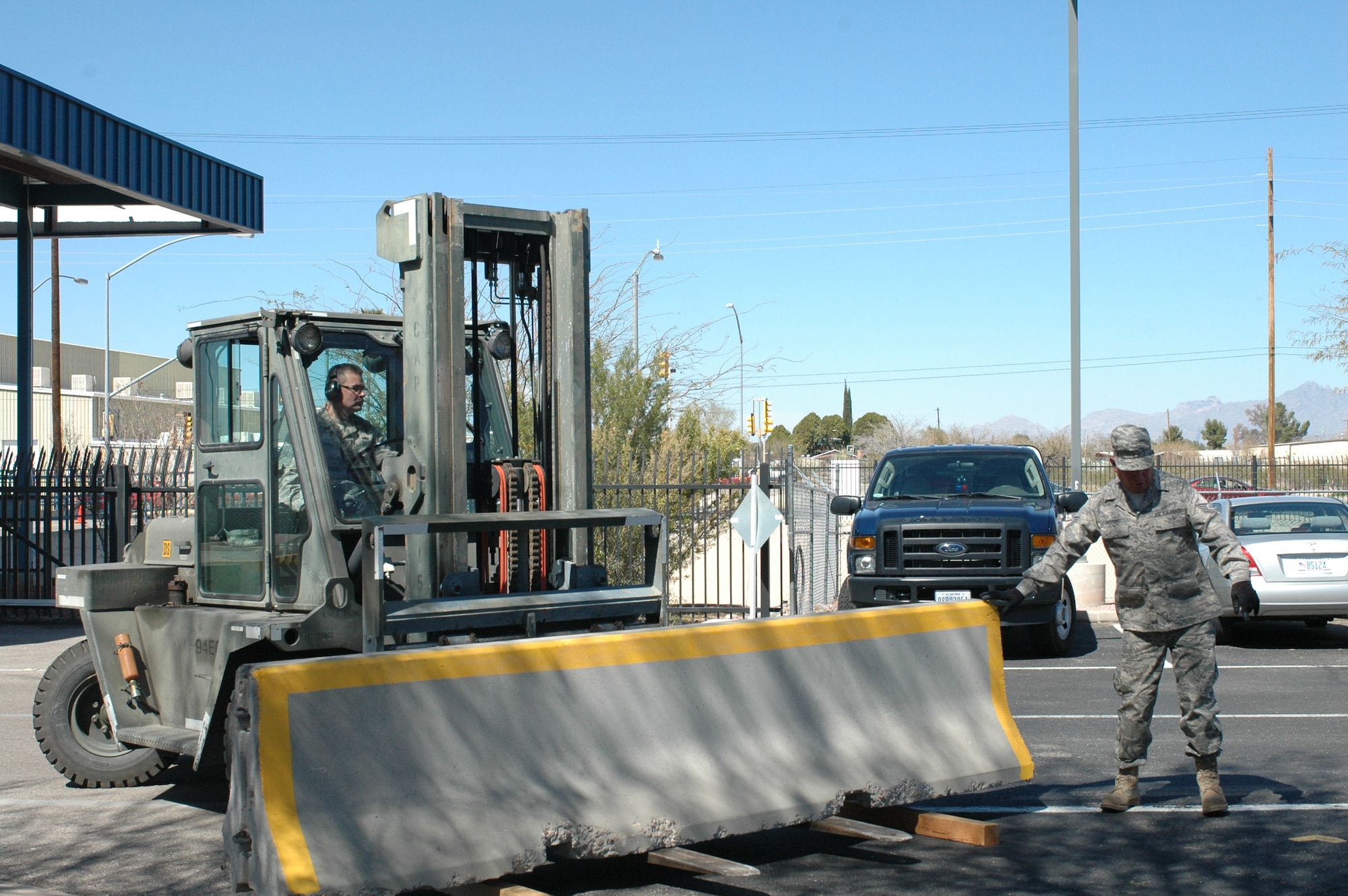 Arizona Air National Guardsmen place barriers on base roads March 13 as part of a compliance inspection exercise. The 162nd Fighter Wing at Tucson International Airport is hosting an inspection team from Air Education and Training Command March 10-16. (Air Force photo by Tech. Sgt. Desiree Twombly)