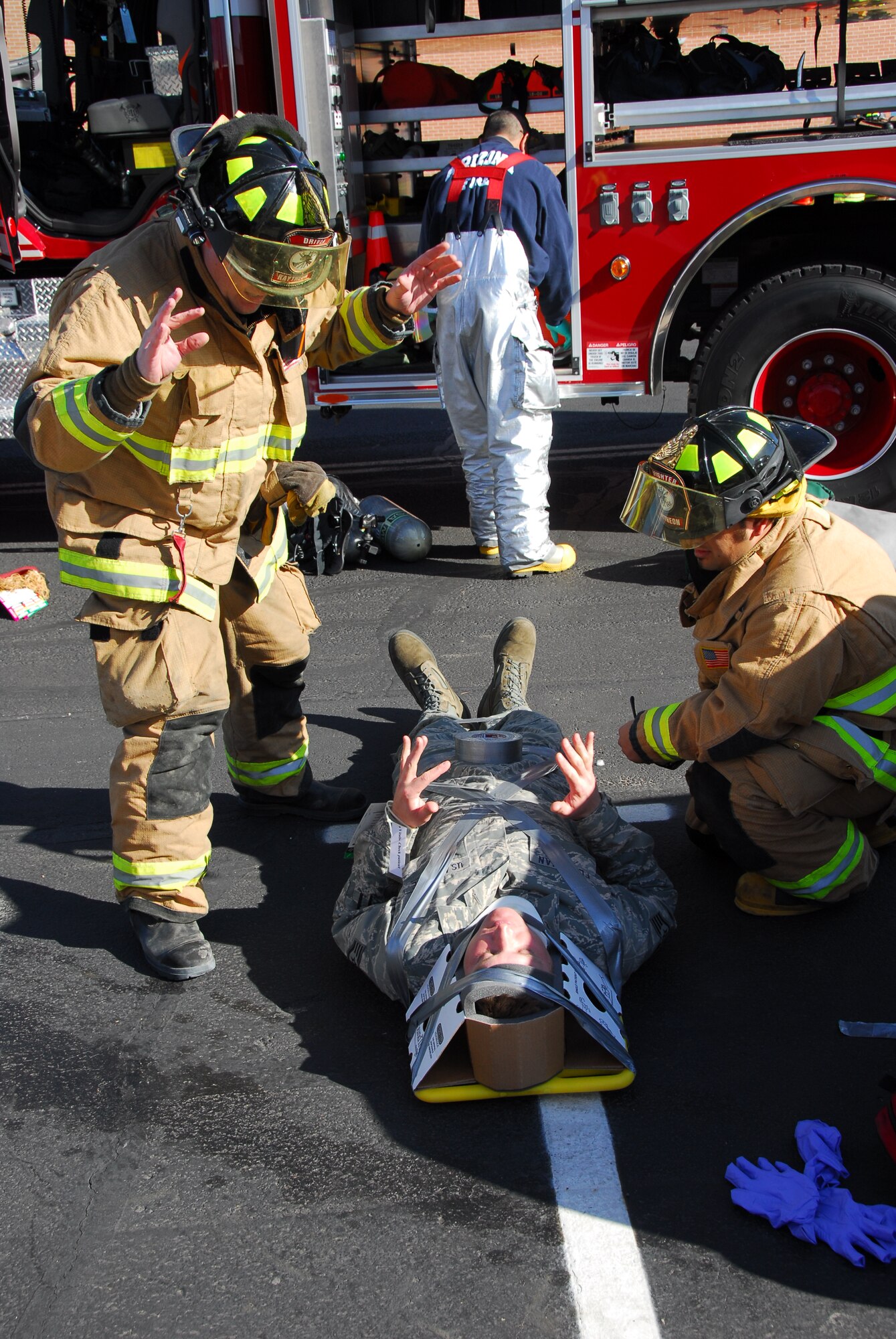 First responders from the base fire station secure an injured Guardsman during a simulated accident March 12 as part of a compliance inspection exercise. The 162nd Fighter Wing at Tucson International Airport is hosting an inspection team from Air Education and Training Command March 10-16. (Air Force photo by Master Sgt. Dave Neve)