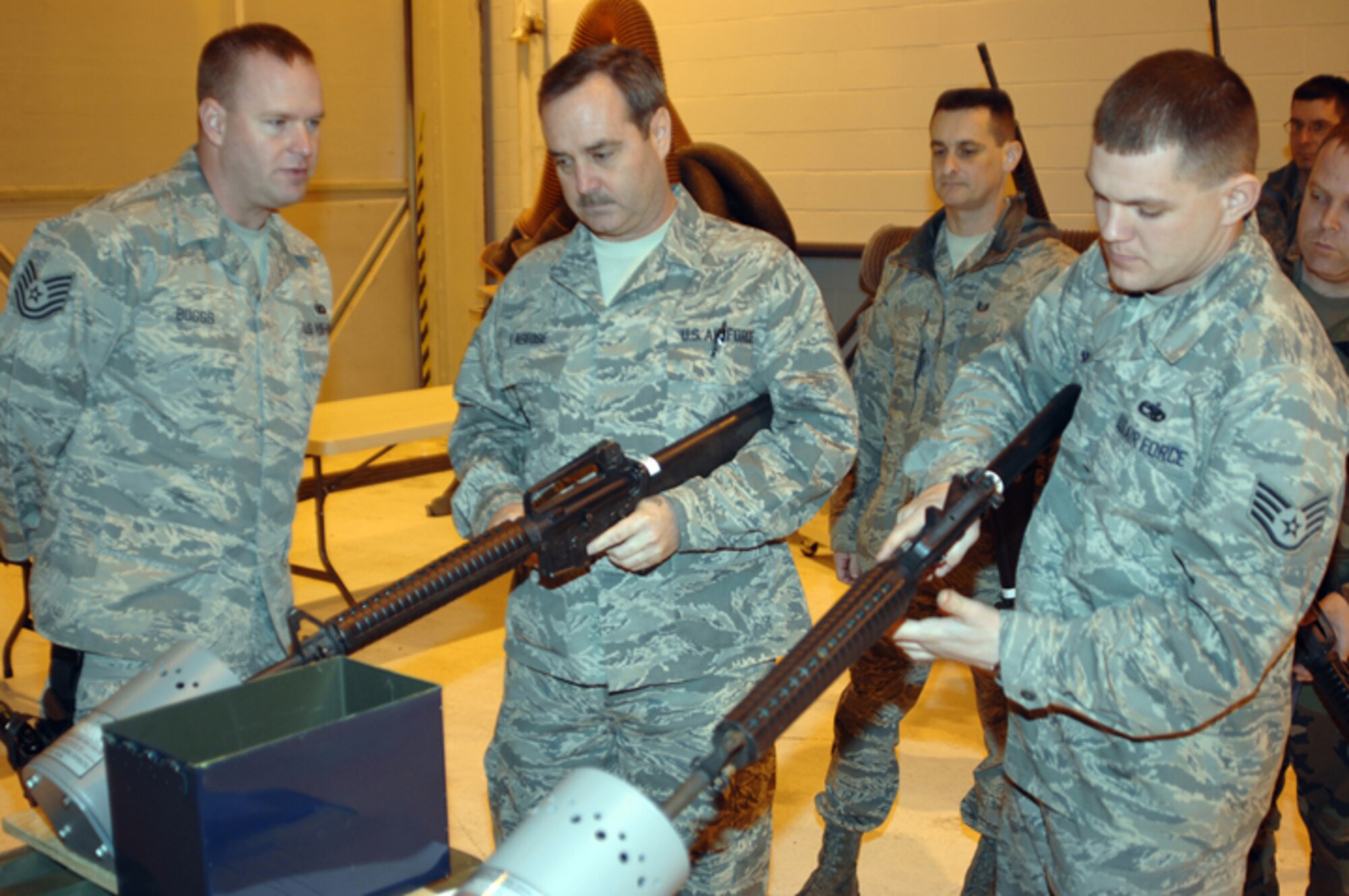 GRISSOM AIR RESERVE BASE, Ind. -- Proper weapons safety is important, because it helps prevent weapon mishaps. Tech. Sgt. Timothy Boggs, 434th Security Forces Squadron member, gives step-by-step M-16 clearing instructions to Master Sgt. Joseph Lageose, 434th Aircraft Maintenance Squadron sortie support flight chief, and Joseph Meyer, 434th AMXS crew chief. (U.S. Air Force photo/Senior Airman Carl Berry)