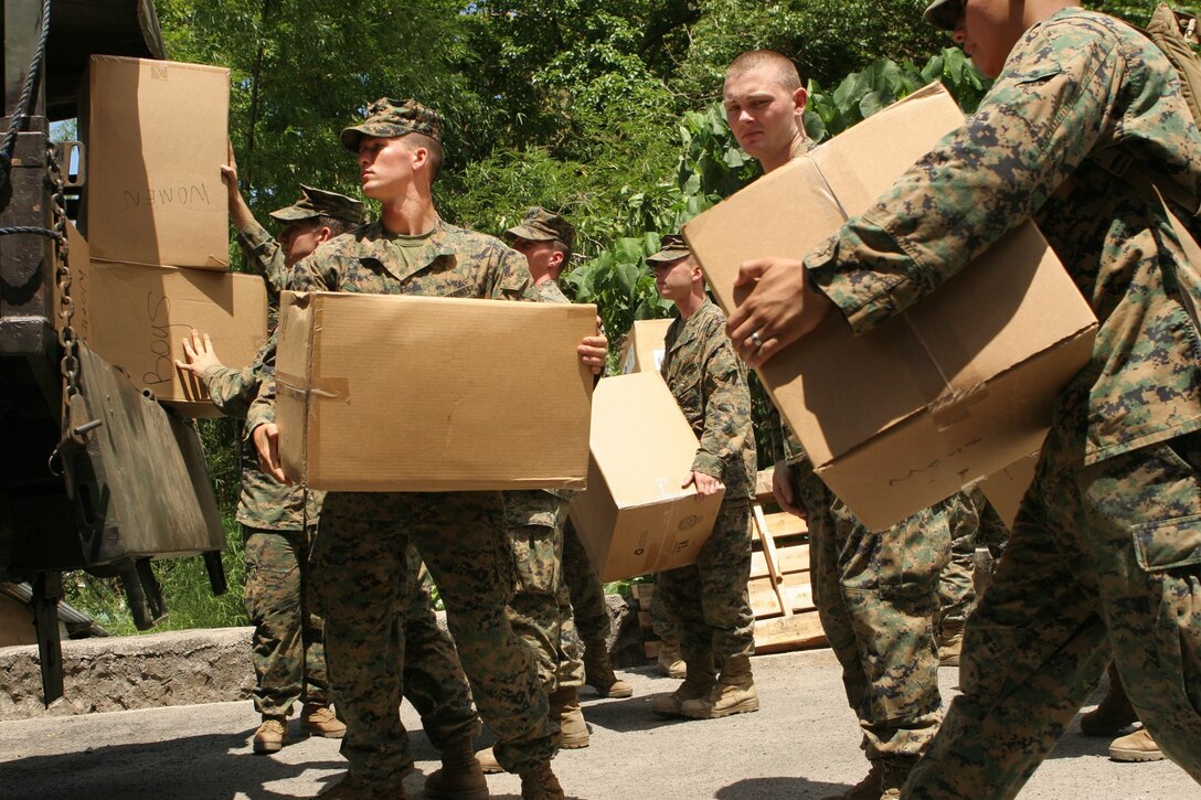 Marines and sailors with Battalion Landing Team, 2nd Battalion, 7th Marine Regiment, 31st Marine Expeditionary Unit, load boxes filled with clothes, toys, and school supplies for a community relations project (COMREL) at San Juan Elementary School, March 15. The supplies were donated by families and U.S. servicemembers from Okinawa, Japan.  Armed Forces of the Philippines (AFP) and U.S. servicemembers conduct COMREL events around the country in conjunction with medical, dental projects, and bilateral training exercises during Balikatan 2010 (BK ’10). (Official Marine Corps photo by Staff Sgt. Leo A. Salinas)