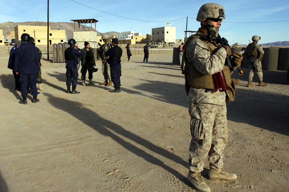 Petty Officer 3rd Class Robert Wollman, a corpsman with Police Mentor Team 2, 3rd Battalion, 3rd Marine Regiment, based out of Marine Corps Base Kaneohe Bay, Hawaii, stands watch at an entry control point March 16 at Combat Center Range 220. The team is expected to deploy in support of Operation Enduring Freedom.
