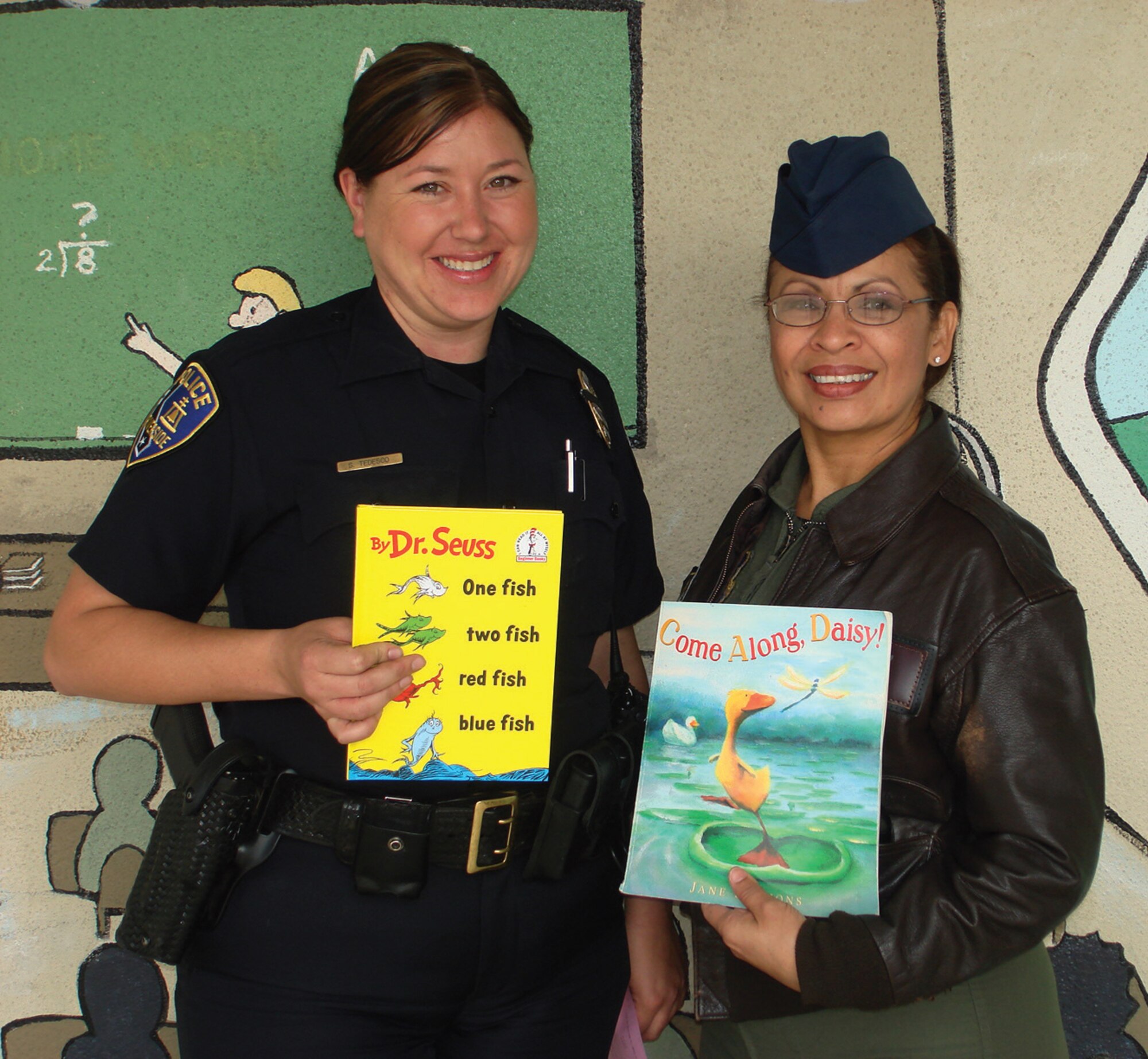 Master Sgt. Jo Carillo (right) and Officer Stacie Tedesco pose with the books they read to students of Arlanza Elementary School in Riverside, Mar. 2, as part of the nationwide Read Across America event. Sergeant Carillo is part of the 452nd Aeromedical Evacuation Squadron at March ARB. (Photo courtesy of Master Sgt. Jo Carillo)