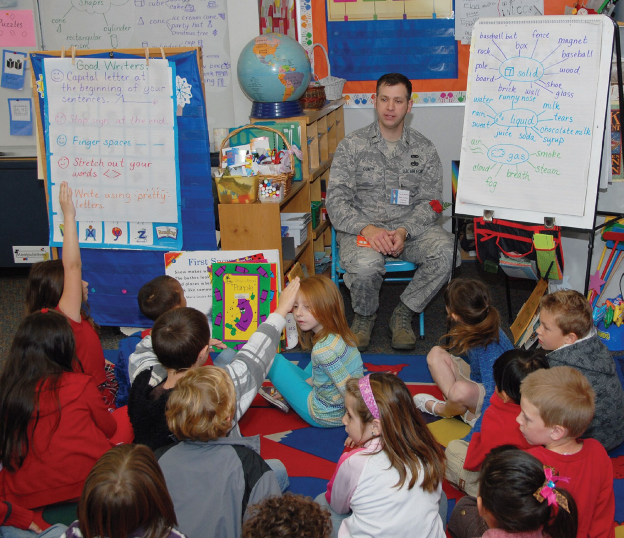 Maintenance officer 1st Lt. David Gunty reads to Mrs. Huynh’s kindergarten class during Read Across America Mar. 2. Nine other members of the 163rd Reconnaissance Wing participated in the event. (U.S. Air Force photo by Staff Sgt. Paul Duquette)