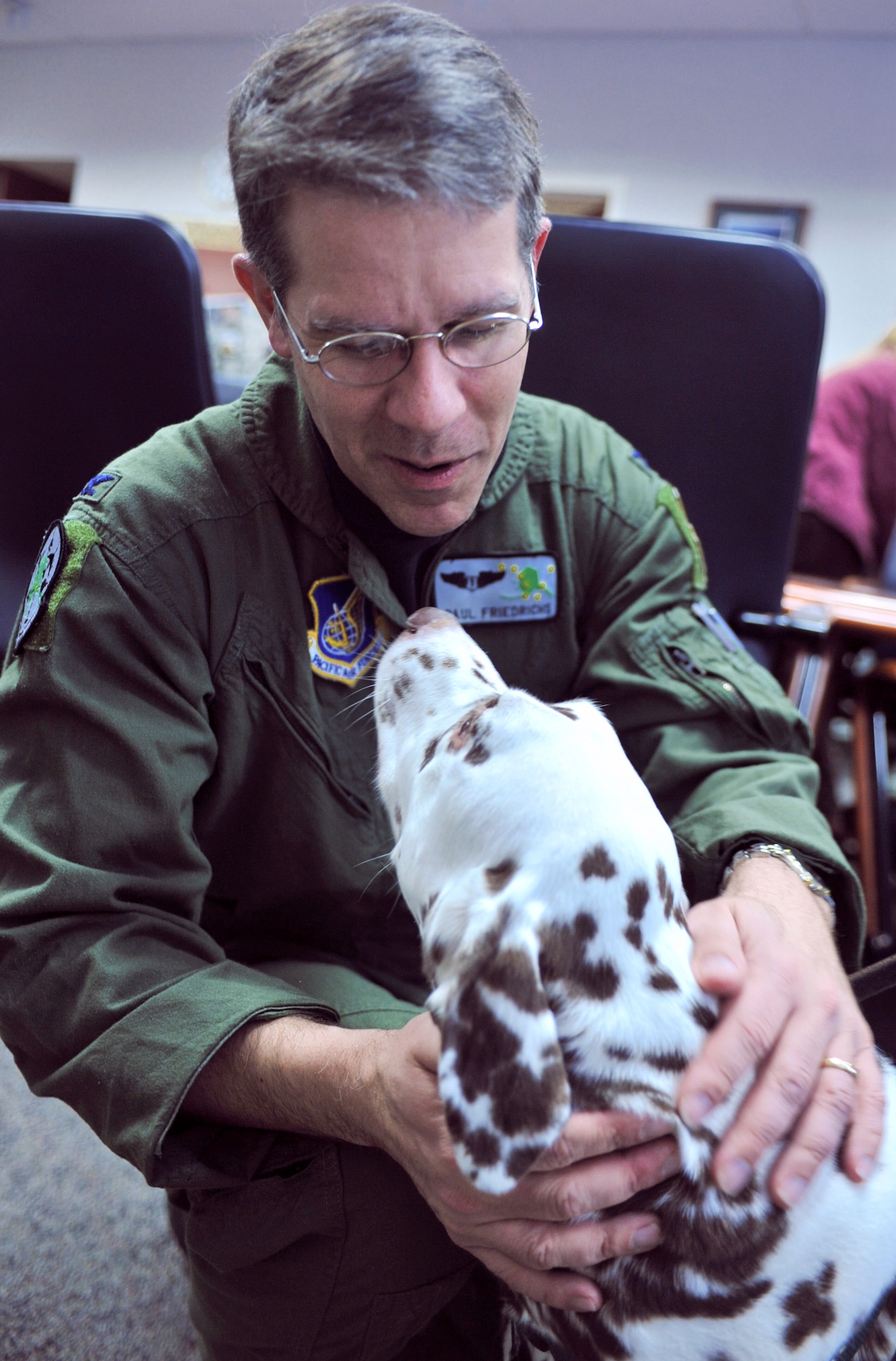 ELMENDORF AIR FORCE BASE, Alaska -- Col. (Dr.) Paul Friedrichs introduces himself to Katie, a 7-year-old dalmatian, during the animal-assisted therapy conference at the Elmendorf's hospital March 12. Katie is pet partner team member who will be working with the 3rd Medical Group physicians to help patients with their medical recovery. Friedrichs is the 3rd Medical Group commander. (U.S. Air Force photo/Senior Airman David Carbajal)