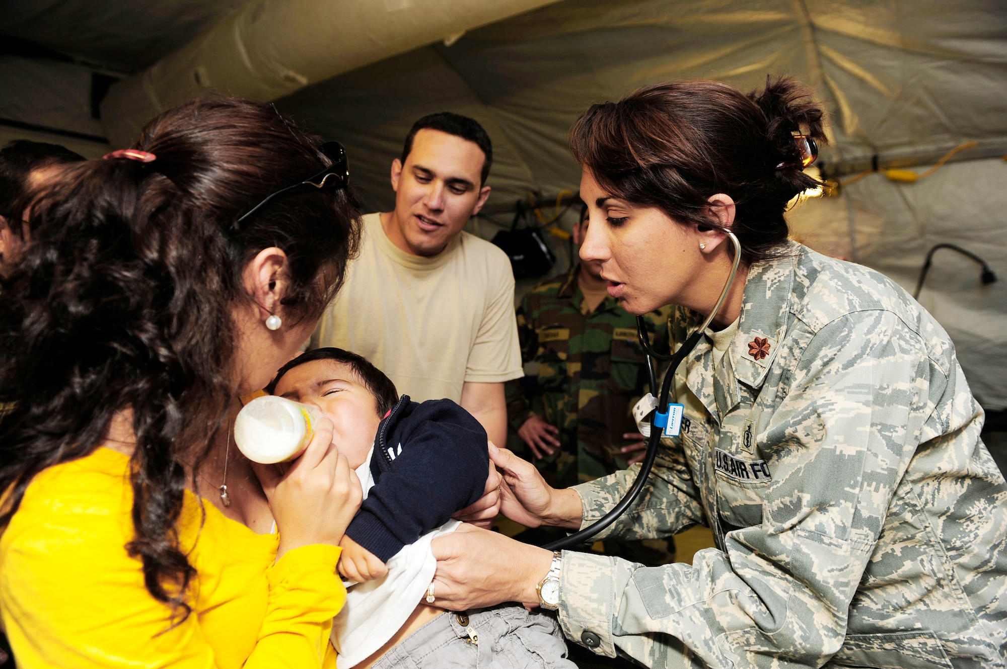Maj. Deena Sutter checks the heartbeat of an ill child at an expeditionary hospital March 14, 2010, in Angol, Chile. Airmen from an Air Force Expeditionary Medical Support team along with members of the Chilean army built a mobile hospital here to help augment medical services for nearly 110,000 Chileans in the region. Major Sutter is assigned to the 59th Medical Wing, Wilford Hall Medical Center at Lackland Air Force Base, Texas. (U.S. Air Force photo/Senior Airman Tiffany Trojca)