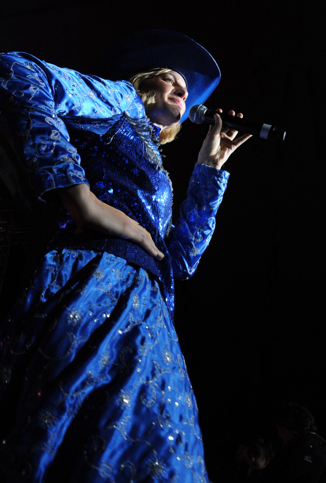 Senior Airman Megan Kelly, 22nd Intelligence Squadron, sings with Tops in Blue Mar 6 at the Greyhound Arena as the audience claps to the beat. The mission of Tops in Blue continues to grow as they directly support overseas operations. (U.S. Air Force photo by Airman 1st Class Maynelinne De La Cruz)