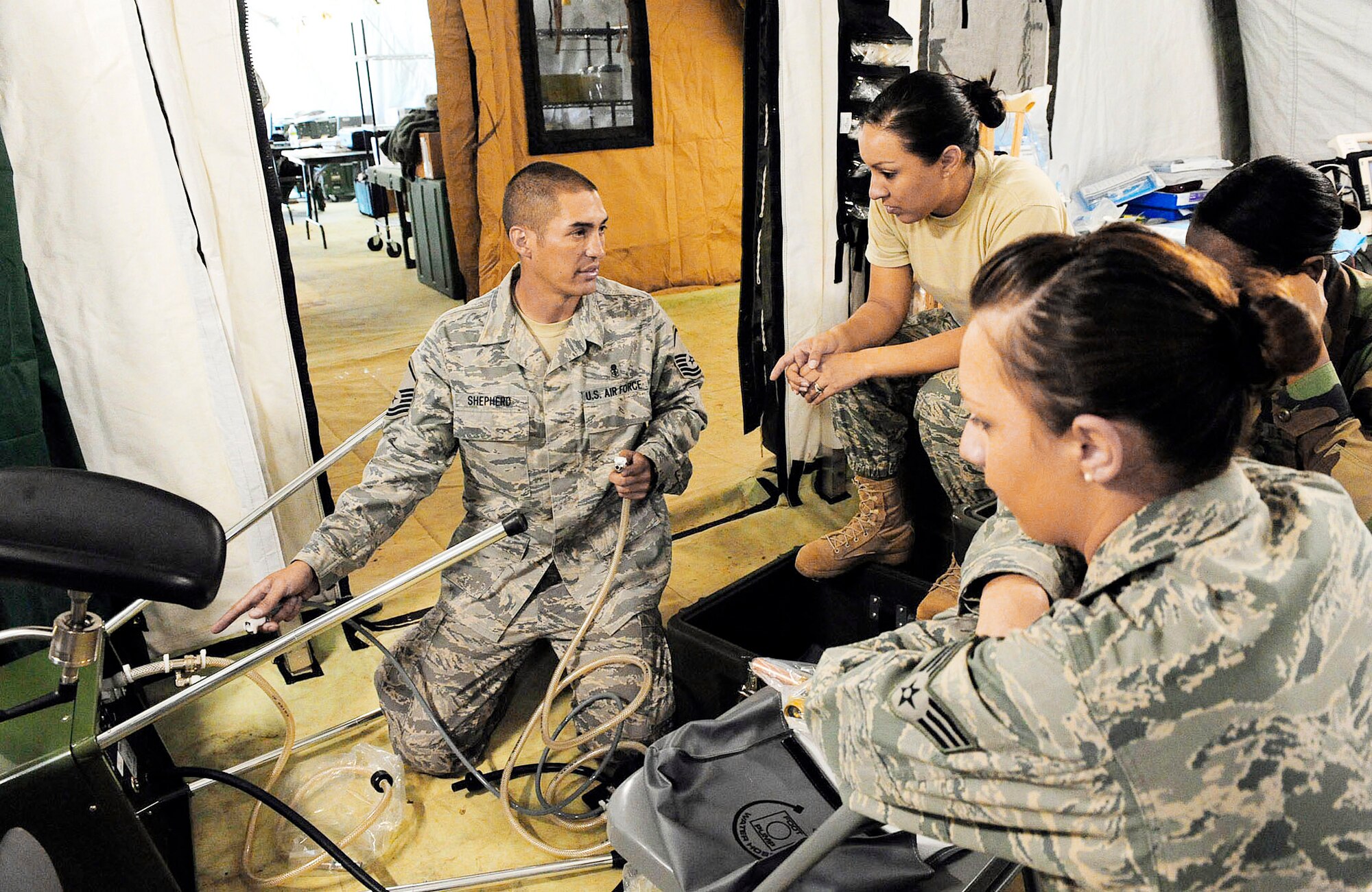 Master Sgt. Joel Shepherd teaches Airmen how to install a field sink in an expeditionary hospital March 13, 2010, in Angol, Chile. The Airmen are part of an Air Force Expeditionary Medical Support team building a mobile hospital here to help augment medical services for nearly 110,000 Chileans in the region. Sergeant Shepherd is assigned to the 81st Aerospace Medical Squadron at Keesler Air Force Base Miss. (U.S. Air Force photo/Senior Airman Tiffany Trojca)