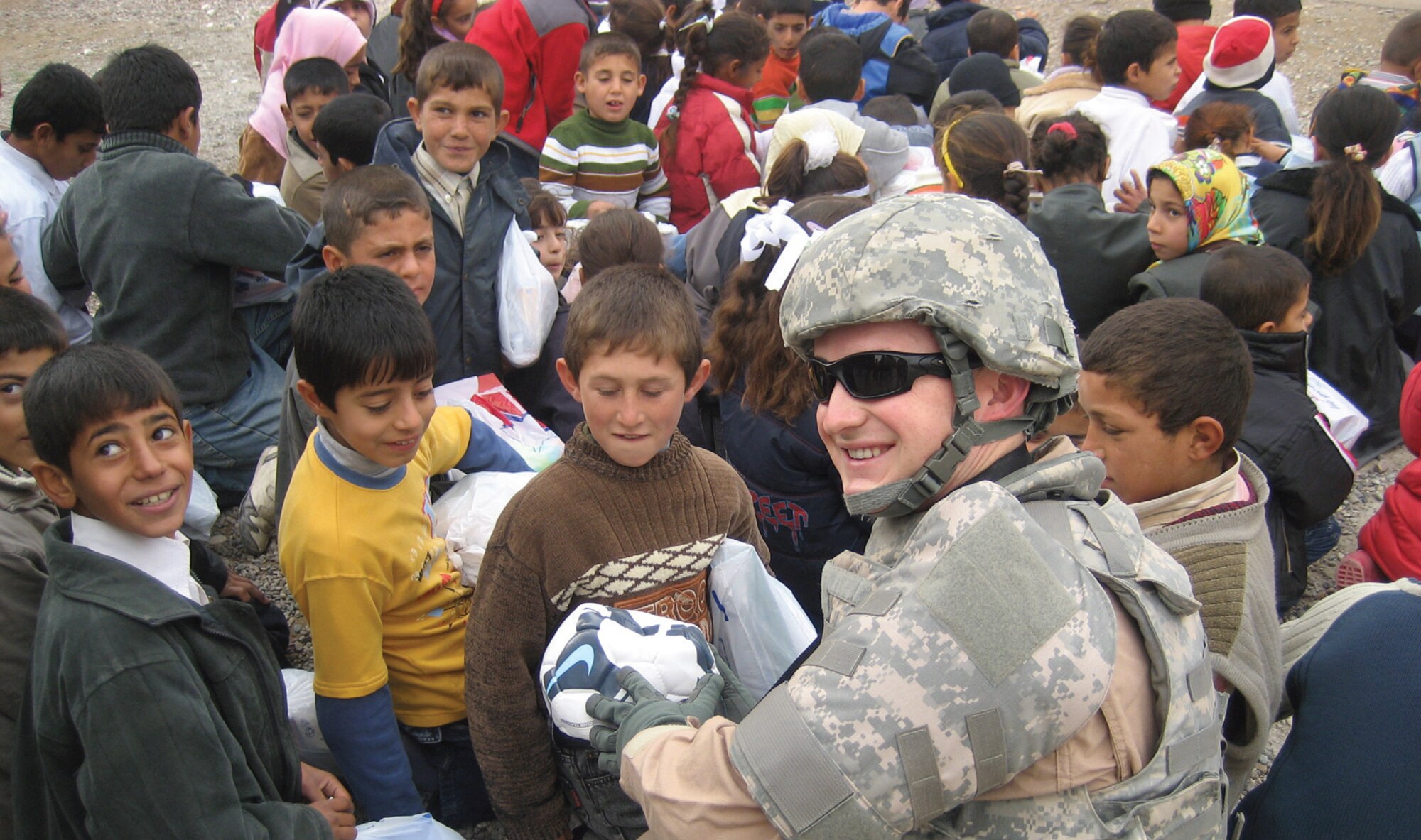 Children in Kirkuk, Iraq, were the excited recipients of Denali Linton’s soccer balls. “My buddy Senior Airman Bobby Evans (pictured) went outside the wire to distribute those soccer balls,” said Master Sgt. William Chang, 297th ATCS, Hawaii Air National Guard. Sergeant Chang sent the photo back so their ‘Soccer Angel’ could see the smiling faces of the children in Iraqi who received the balls. “The Iraq children’s eyes just open up when they see a gift like this; they truly love the sport of soccer,” said Sergeant Chang. For more information regarding Operation Soccer Ball, visit www.operationsoccerball.org. ( U.S. Air Force Photos/ Master Sgt. William Chang)