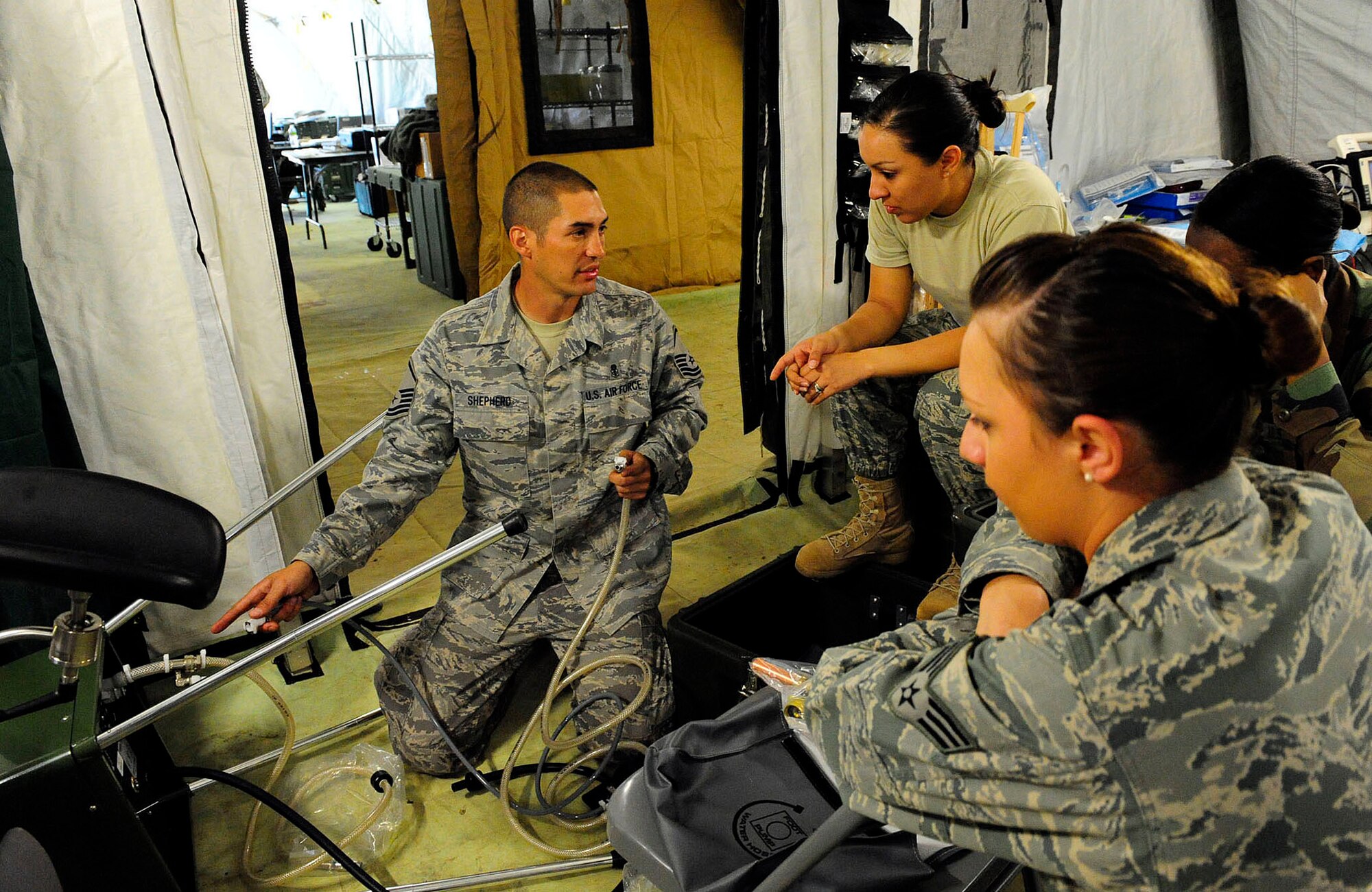 Master Sgt. Joel Shepherd teaches Airmen how to install a field sink in an expeditionary hospital March 13, 2010, in Angol, Chile. The Airmen are part of an Air Force Expeditionary Medical Support team building a mobile hospital here to help augment medical services for nearly 110,000 Chileans in the region. Sergeant Shepherd is assigned to the 81st Aerospace Medical Squadron at Keesler Air Force Base Miss. (U.S. Air Force photo/Senior Airman Tiffany Trojca)
