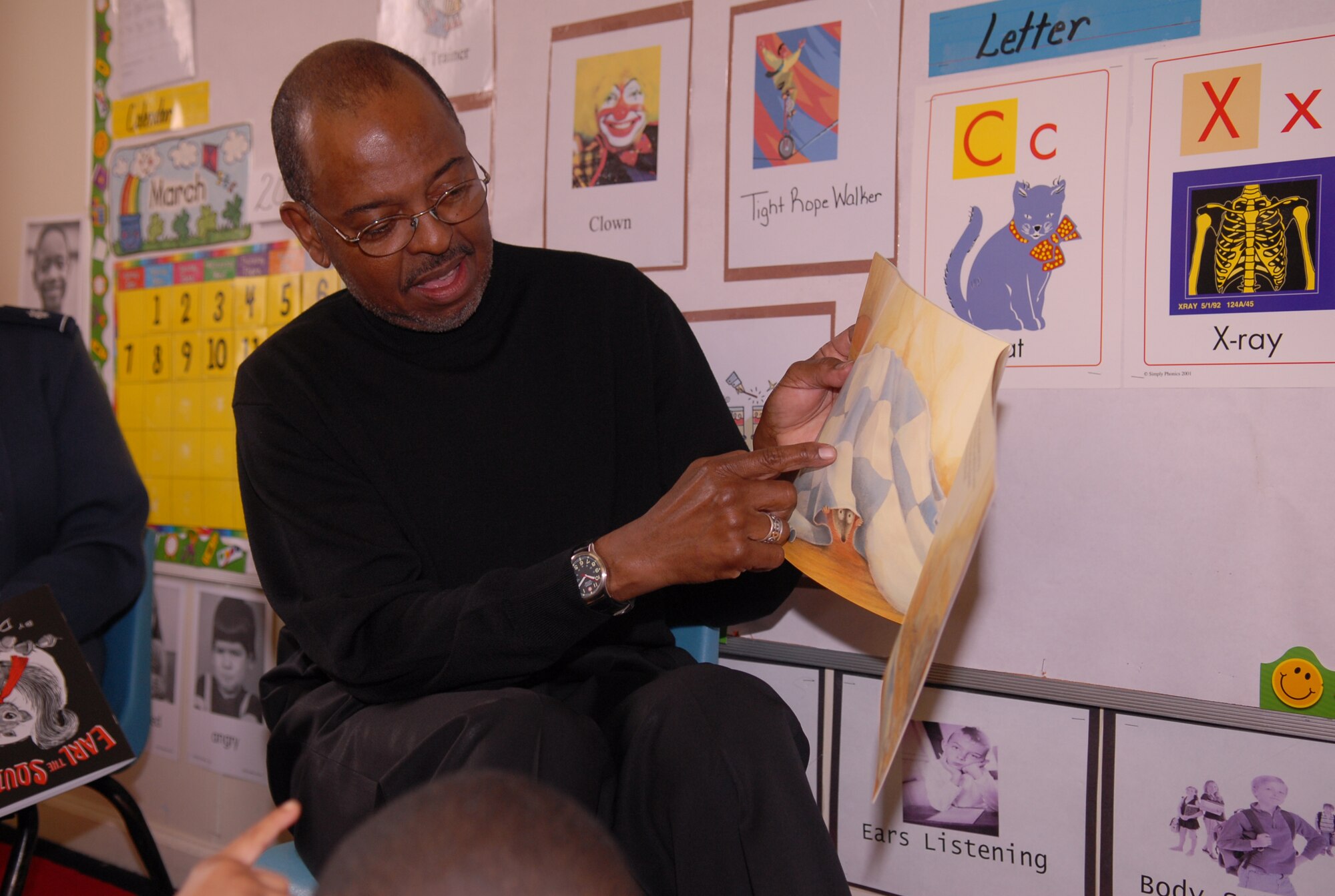 Robert Hines, 43rd Medical Operations Squadron Honorary Commander, President and Chief Executive Officer of the Cumberland County United Way, reads children's books to students in a Head Start classroom in Fayetteville March 11. (U.S. Air Force Photo/ 2nd Lt. Cammie Quinn)