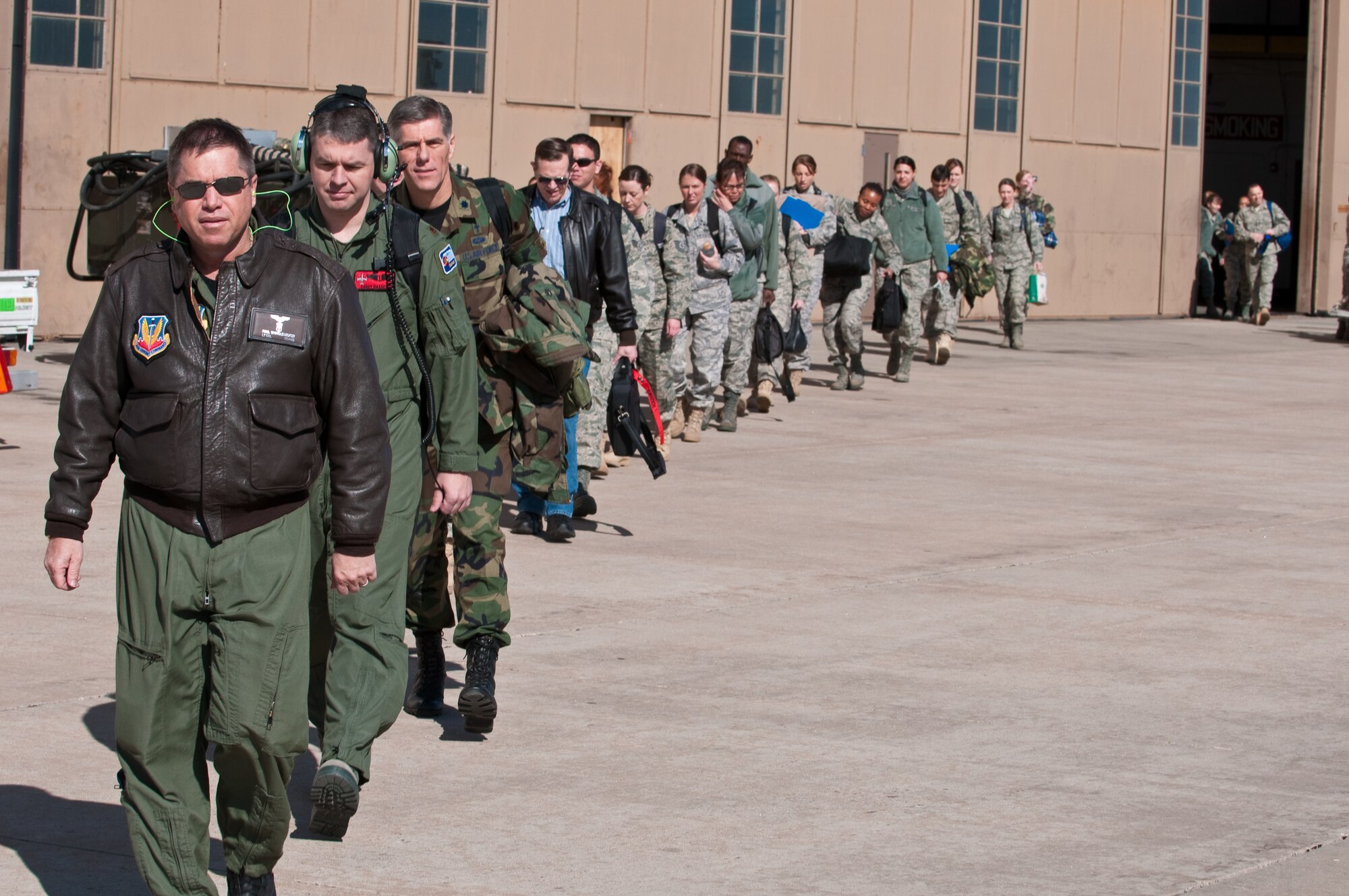 U.S. Air Force Lt. Col. Paul Shingledecker, Commander, 140th Medical Group, Colorado Air National Guard, leads his team of physicians, nurses and support personnel out to the flightline to board their flight to Honolulu, March 13, 2010. More than 60 personnel of the 140th Medical Group will be providing services to the medically underserved communities of Oahu. (U.S. Air Force photo/Master Sgt. John Nimmo, Sr.) (RELEASED)
