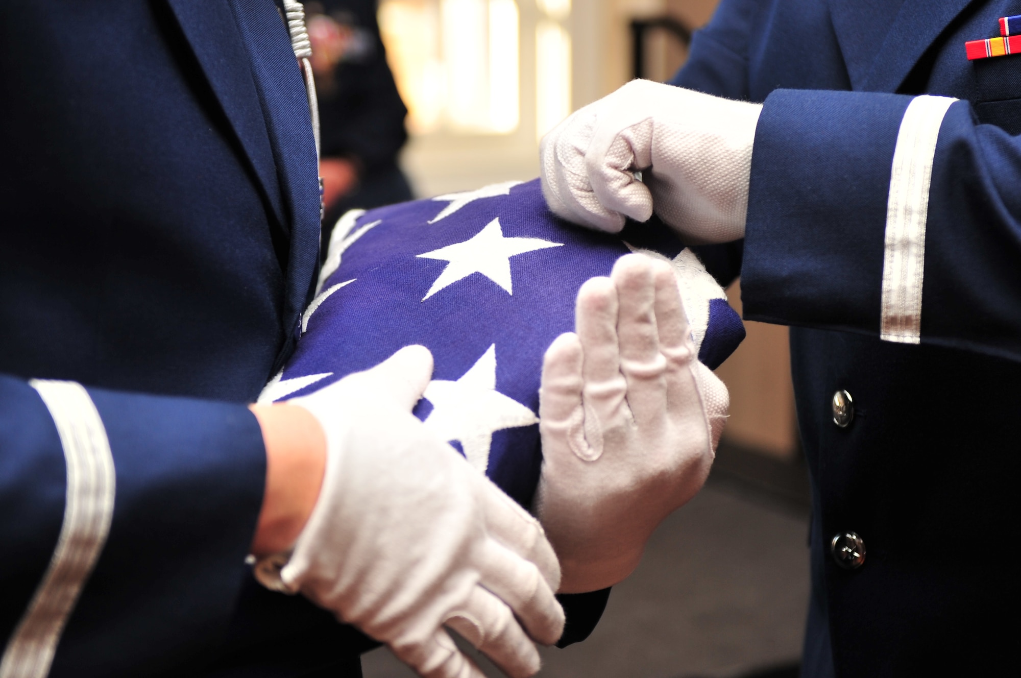 Airmen from the 4th Fighter Wing Honor Guard fold a flag for presentation during a retirement ceremony for Special Agent James Huskey, formerly from the Air Force Office of Special Investigation, on Seymour Johnson Air Force Base, N.C., Feb. 26, 2010. The Seymour Johnson Honor Guard has 44 assigned Airmen including a full-time trainer, ranging in rank from airman basic to technical sergeant from a variety of Air Force specialties. (U.S. Air Force photo/Senior Airman Rae Perry)