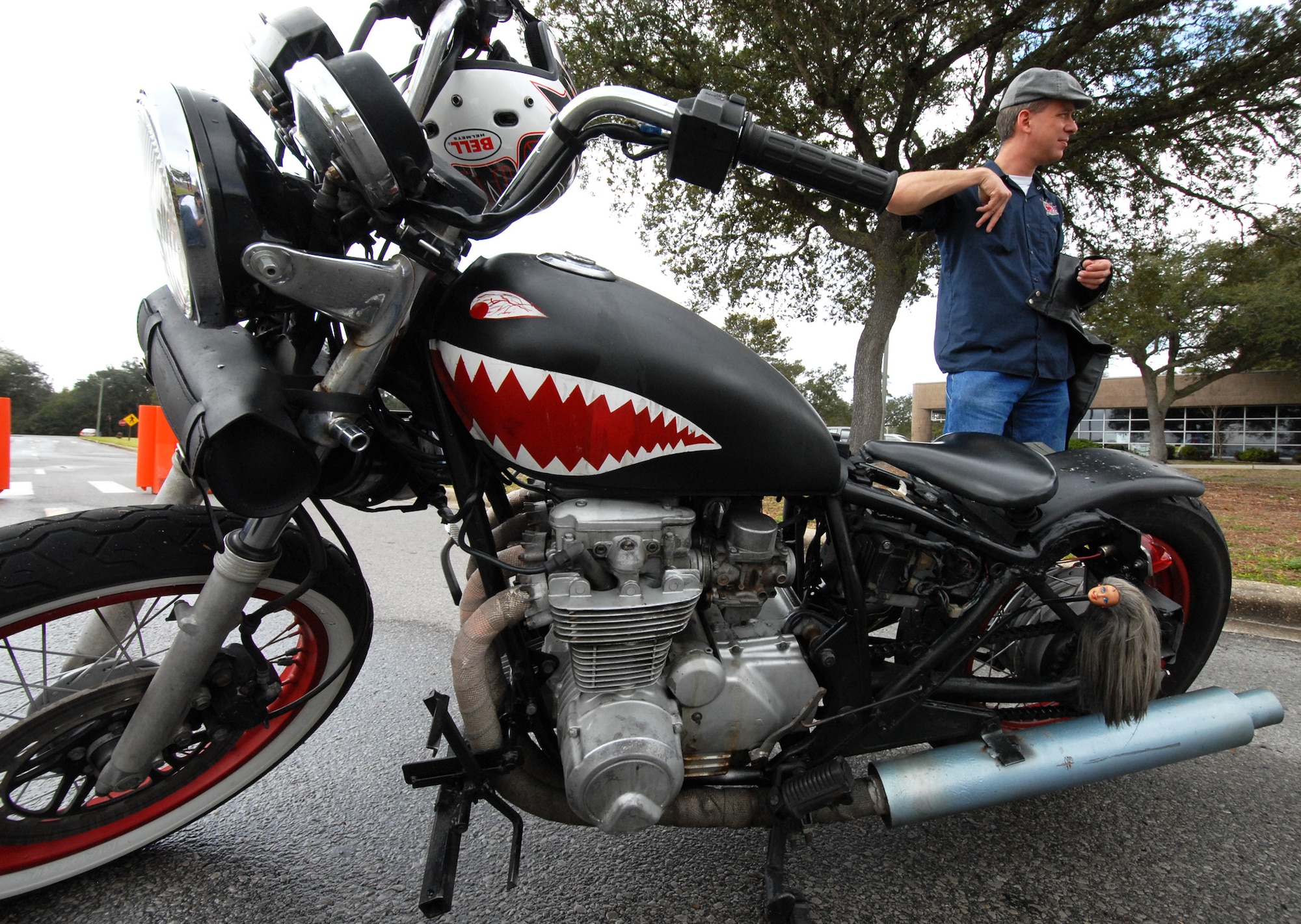 Tech. Sgt. Mike Massey, 96th Aerospace Medical Squadron, waits with his custom bike for the group ride to begin March 12 at Team Eglin's third annual Motorcycle Safety Day.  Despite threatening skies, the event brought out approximately 220 riders to participate in safety discussions, riding skills competition and group ride.  The safety day came at a critical time for Eglin with spring break approaching and a recent active-duty death involving a motorcycle. (U.S. Air Force photo/Samuel King Jr.)
