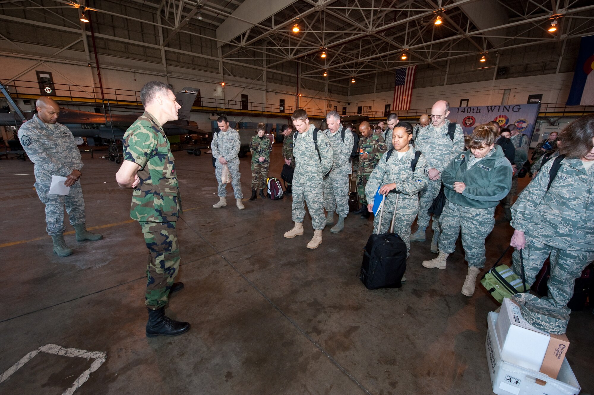 Chaplain Ronald Prosise, 140th Wing, Colorado Air National Guard, conducts a benediction with members of the 140th Medical Group before their departure for Honolulu, March 13, 2010. Prosise is part of a more than 60-person team of physicians, nurses and support personnel working with the Hawaii ANG in support of E Malama Kakou (translated from Hawaiian as “to care for all”) a humanitarian program providing services to the medically underserved within the State of Hawaii. (U.S. Air Force photo/Master Sgt. John Nimmo, Sr.) (RELEASED)