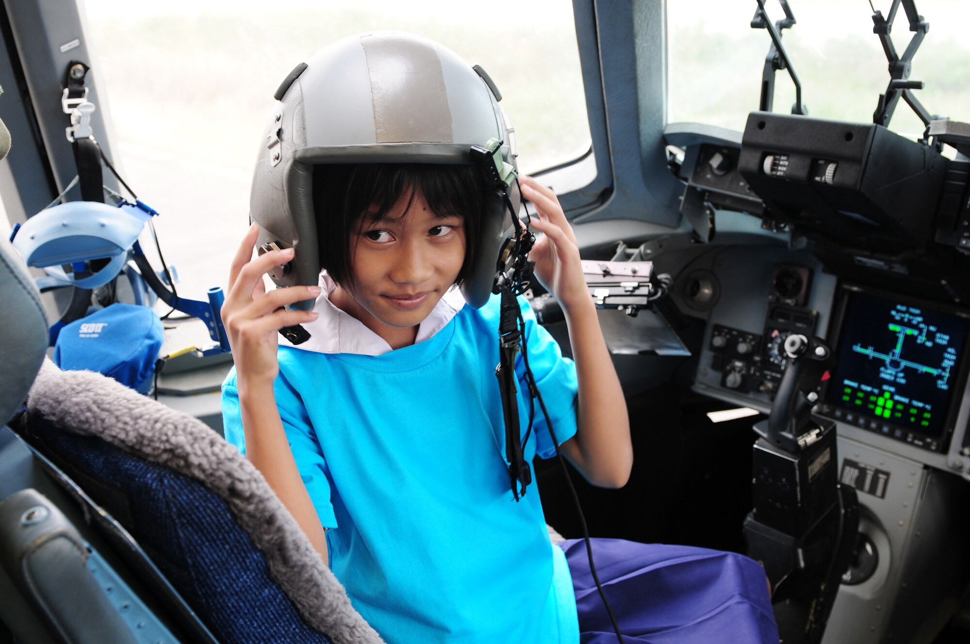 A Thai student enjoys sitting in the cockpit of a C-17 Globemaster III during the Cope Tiger 2010 open house held for more than 50 Thai students March 10 at Udon Thani Royal Thai Air Force Base, Thailand. (U.S. Air Force photo/Capt. Genieve David)
