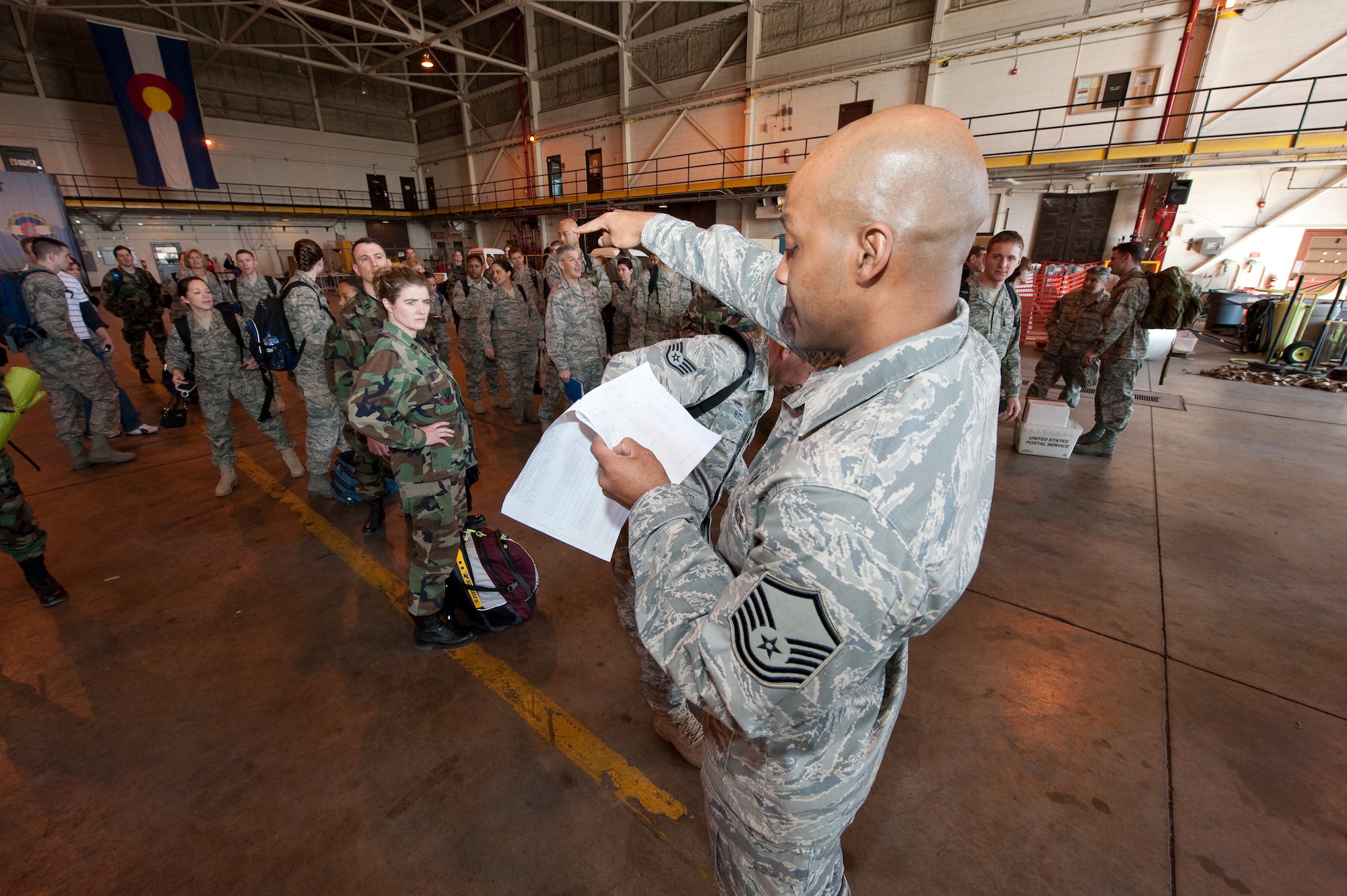 U.S. Air Force Master Sgt. Anthony Cook, First Sergeant for the Colorado Air National Guard’s 140th Medical Group at Buckley Air Force Base, conducts a final roll-call in preparation for the groups departure to Honolulu, March 13, 2010. Cook is part of a more than 60-person team supporting E Malama Kakou (translated from Hawaiian as “to care for all”) an Innovative Readiness Training Program providing service to medically underserved communities within the State of Hawaii. (U.S. Air Force photo/Master Sgt. John Nimmo, Sr.) (RELEASED)