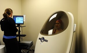 LANGLEY AIR FORCE BASE, Va.-- Anne Jennings, Health and Wellness Center health fitness specialist, reads data from a Bod Pod test that Senior Airman Sylvia Olson, 633d Air Base Wing Public Affairs journalist, took part in March 9. The Bod Pod measures body mass, or weight, and body volume using air displacement technology.  Using these two variables, body density is computed and used with an equation to provide body composition information. (U.S. Air Force photo/Senior Airman Dana Hill)