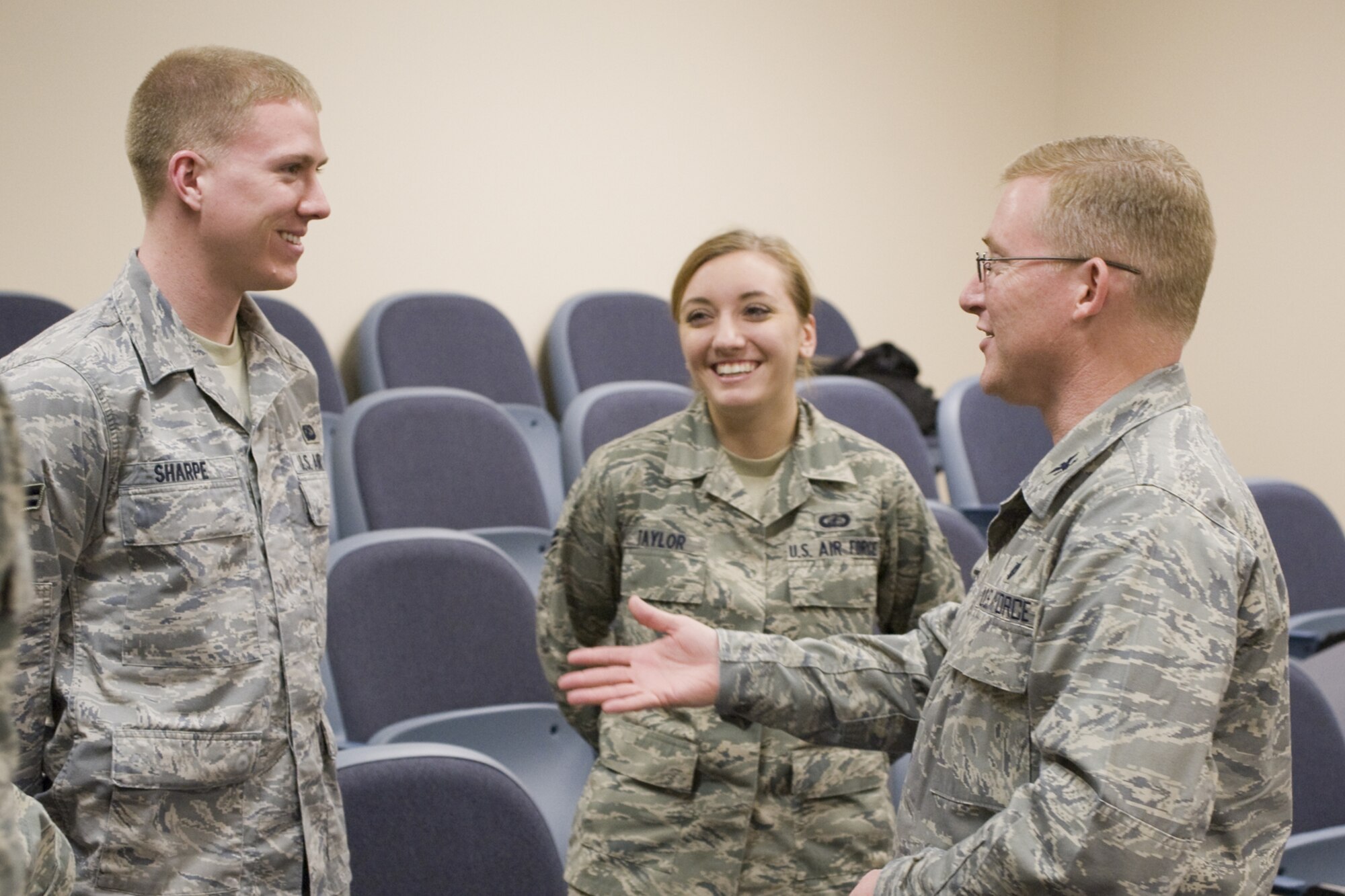 Airmen 1st Class Robert Sharpe, Financial Services Technician  and Courtney Taylor, Customer Service Technician,  chat with Col. Allen Blume, Air Force Global Strike Command financial mamager, following his all-calll in the 341st Comptroller Squadron conference room, March 20. (U.S. Air Force photo/Beau Wade)