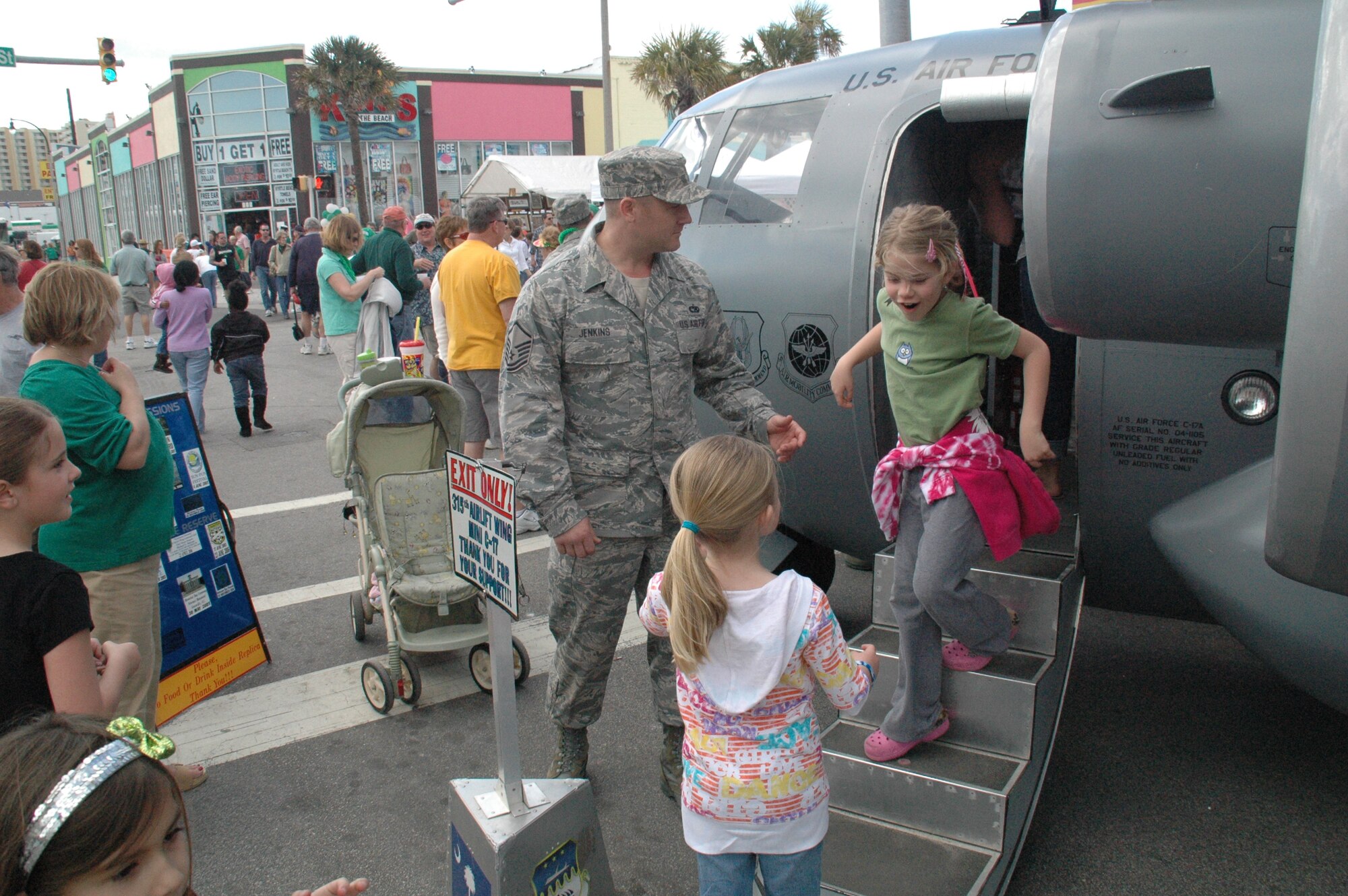 Master Sergeant Alan Jenkins treats the masses to a merry pot-o-gold, Air Force style. Sergeant Jenkins is an Air Force Reserve Recruiter with the 315th Airlift Wing at the Charleston Air Force Base, S.C. The 315 AW's miniature replica of the C-17 made a much welcomed appearance Saturday at the North Myrtle Beach St. Patrick's Day Parade and Festival. The Mini C-17 is the wing's community outreach and recruiting tool, available for display at community events.(Air Force photo by/Captain Wayne Capps).
