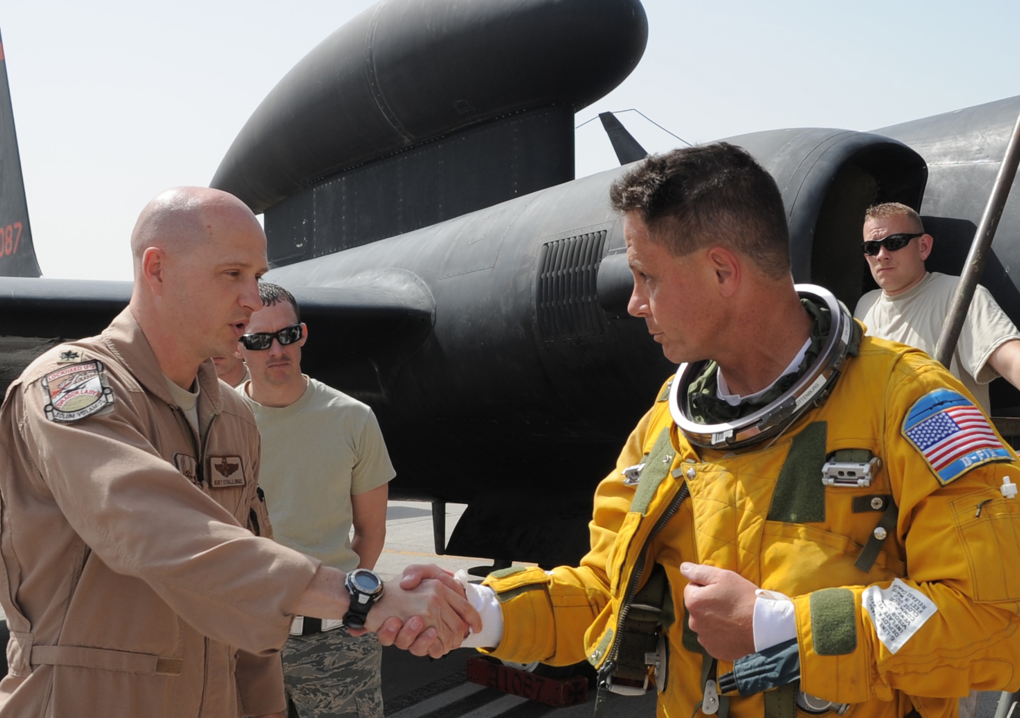 Lt. Col. Kirt Stallings, commander of the 99th Expeditionary Reconnaissance Squadron, congratulates Maj. William Gottenberg, U-2 pilot with the 99th ERS, after the major completed his 100th combat mission in the U-2 from a non-disclosed base in Southwest Asia on March 9, 2010. Major Gottenberg is deployed from Beale Air Force Base, Calif., and his hometown is Rocklin, Calif. (U.S. Air Force Photo/Master Sgt. Scott T. Sturkol/Released)