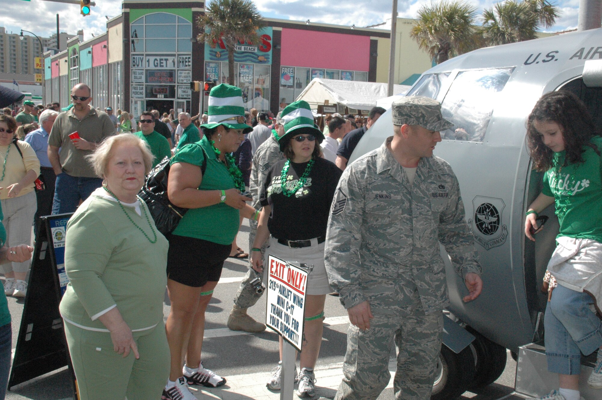 Master Sergeant Alan Jenkins treats the masses to a merry pot-o-gold, Air Force style. Sergeant Jenkins is an Air Force Reserve Recruiter with the 315th Airlift Wing at the Charleston Air Force Base, S.C. The 315 AW's miniature replica of the C-17 made a much welcomed appearance Saturday at the North Myrtle Beach St. Patrick's Day Parade and Festival. The Mini C-17 is the wing's community outreach and recruiting tool, available for display at community events.(Air Force photo by/Captain Wayne Capps).
