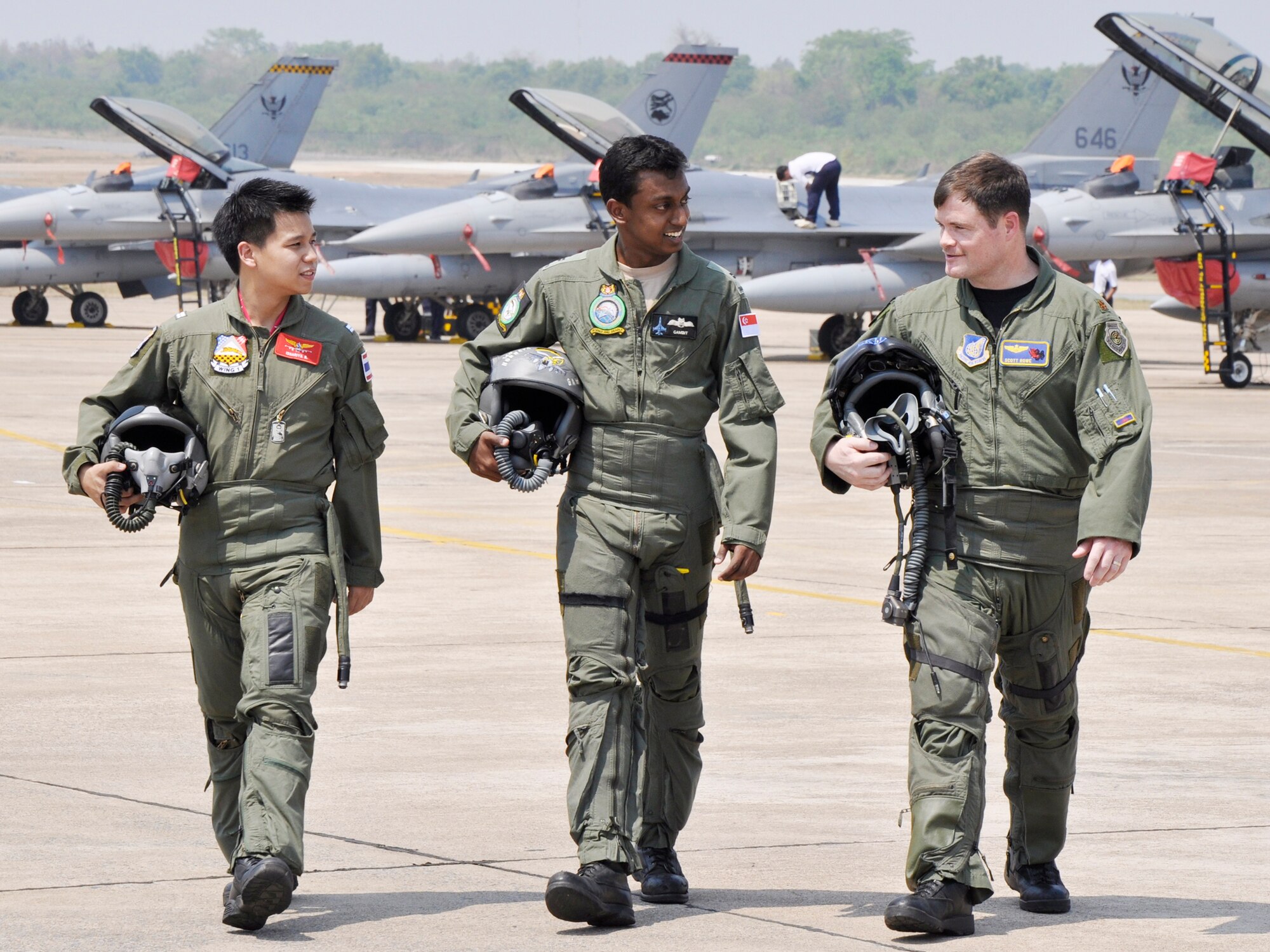 Maj. Scott Rowe (right) talks about his participation in Cope Tiger with his counterparts from the Royal Thai Air Force and the Republic of Singapore Air Force March 8, 2010, at Korat Royal Thai Air Force Base, Thailand. Major Rowe is an F-15 Eagle pilot from the 19th Fighter Squadron at Elmendorf Air Force Base, Alaska. (U.S. Air Force photo/Capt. Christy Stravolo)
