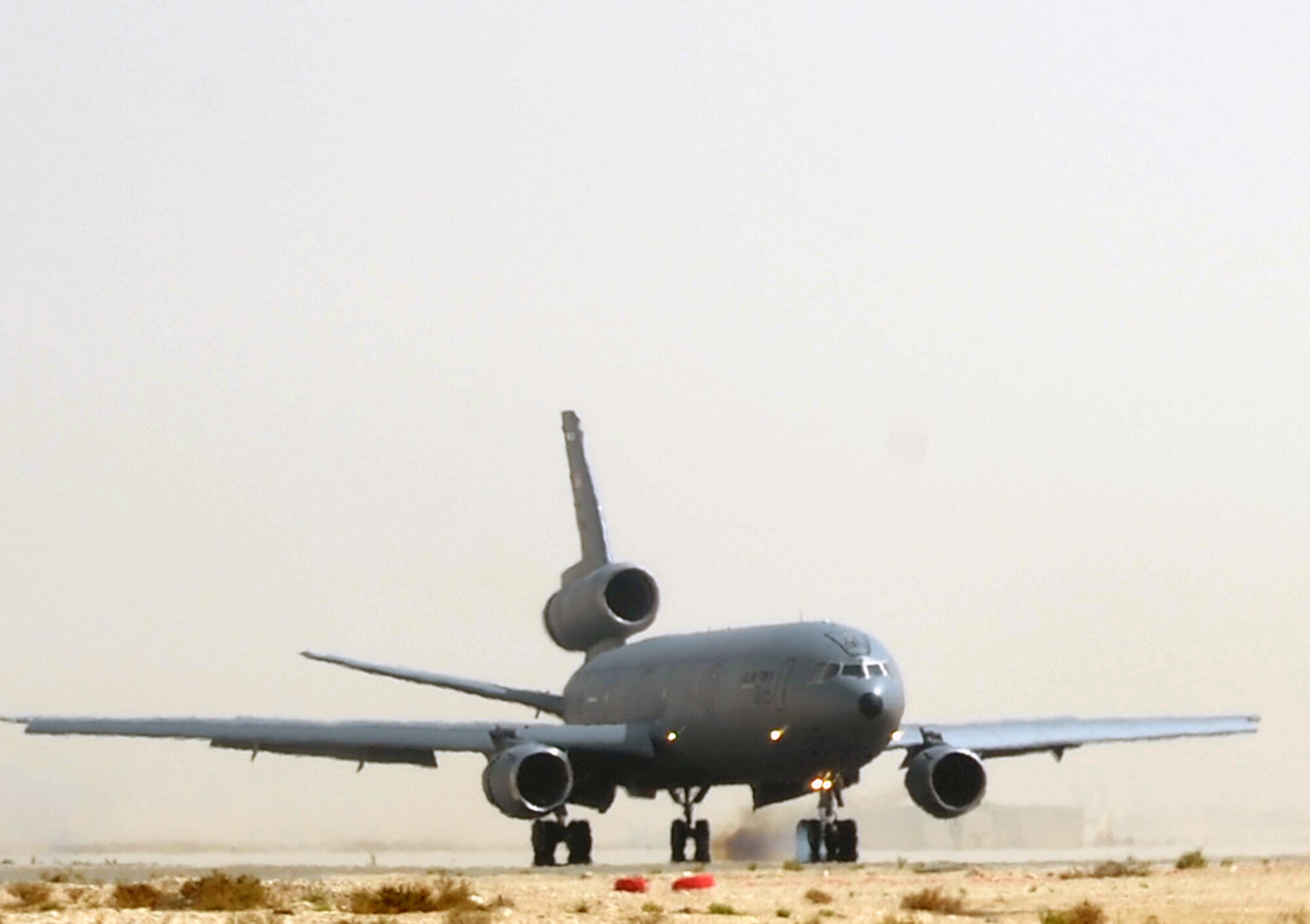 A flight crew guides a KC-10 Extender from the 908th Expeditionary Air Refueling Squadron to a landing at a non-disclosed base in Southwest Asia on March 9, 2010. The 908th EARS, as part of the 380th Air Expeditionary Wing, supports operations Iraqi Freedom and Enduring Freedom and the Combined Joint Task Force-Horn of Africa. (U.S. Air Force Photo/Master Sgt. Scott T. Sturkol/Released)