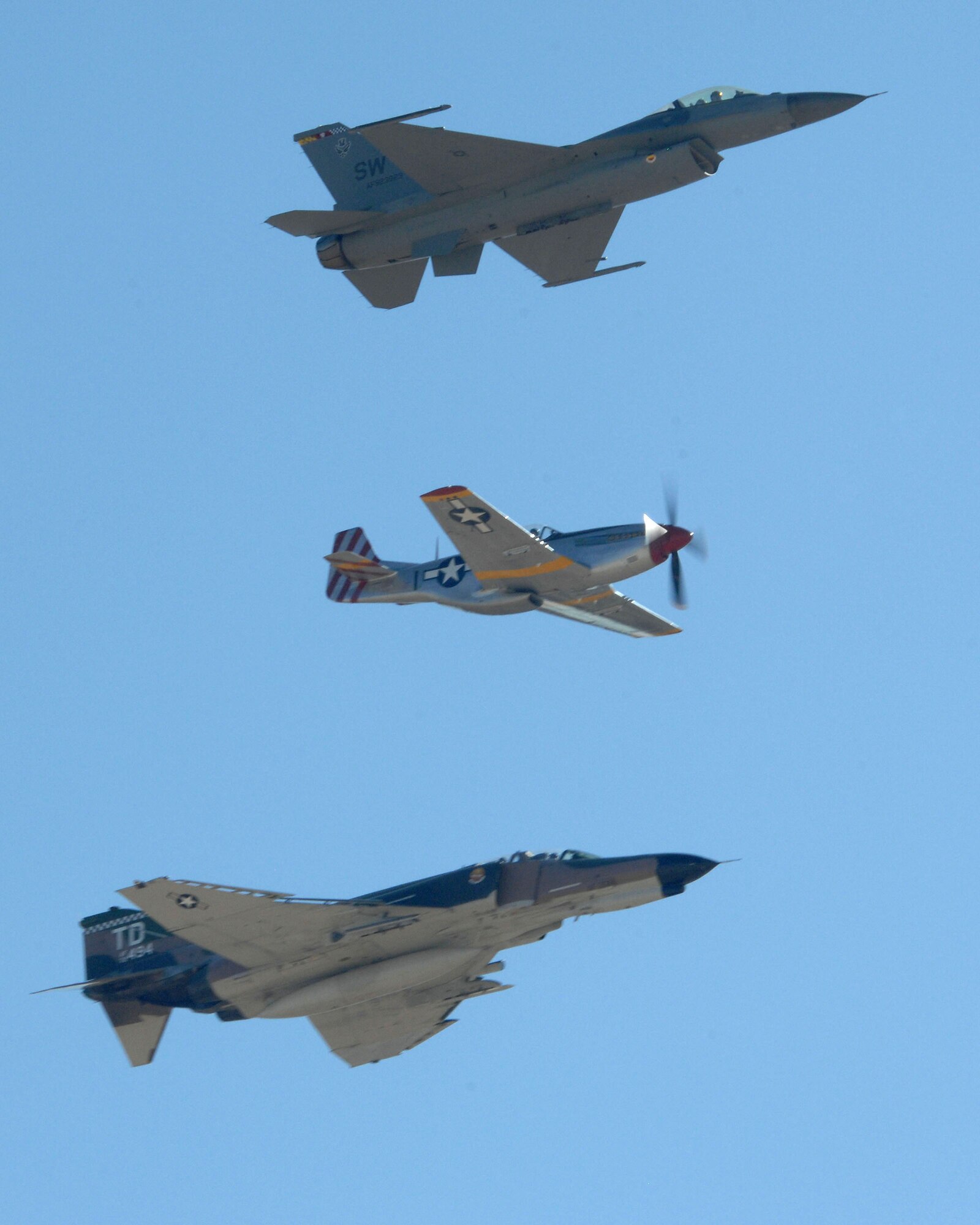 (From top to bottom) An F-16 Fighting Falcon, P-51 Mustang and F-4 Phantom fly in formation over Tucson, Ariz., during the Heritage Flight Conference here March 5. The annual aerial demonstration training event has been held at D-M since 2001, providing civilian and military pilots the opportunity to practice formation flying in advance of the upcoming air show season. (U.S. Air Force photo/Staff Sgt. Alesia Goosic) 