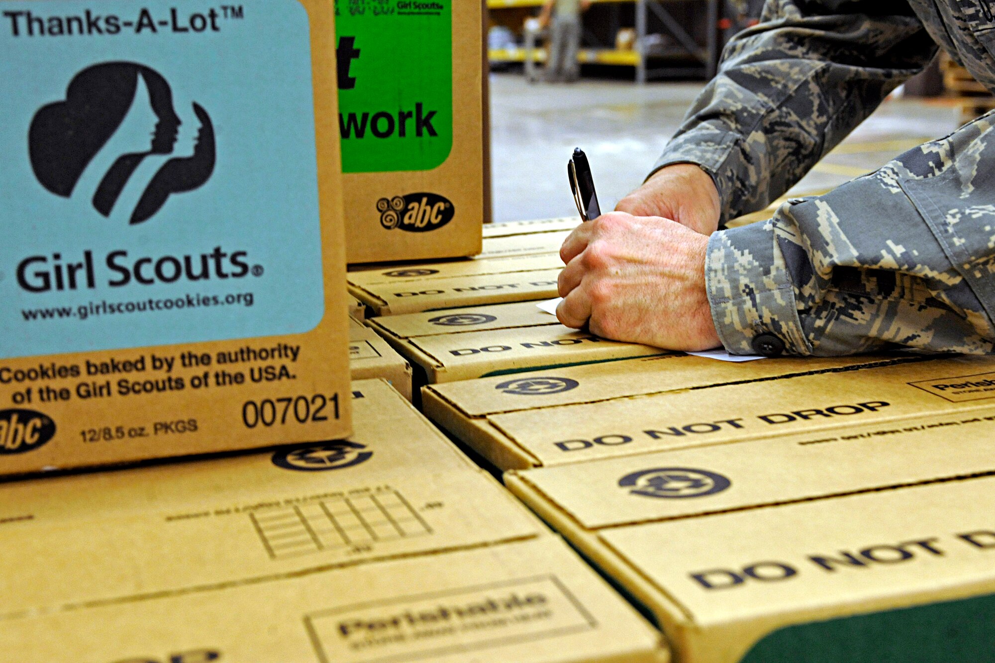 Master Sgt. William Little, 28th Logistics Readiness Squadron compliance and analysis NCO in-charge, approves a pallet of Girl Scout cookies ready for distribution after a quality control inspection, March 13. More than 20 Airmen volunteered to organize boxes of Girl Scout cookies for local troops to distribute. (U.S. Air Force photo/Airman 1st Class Matthew Flynn)