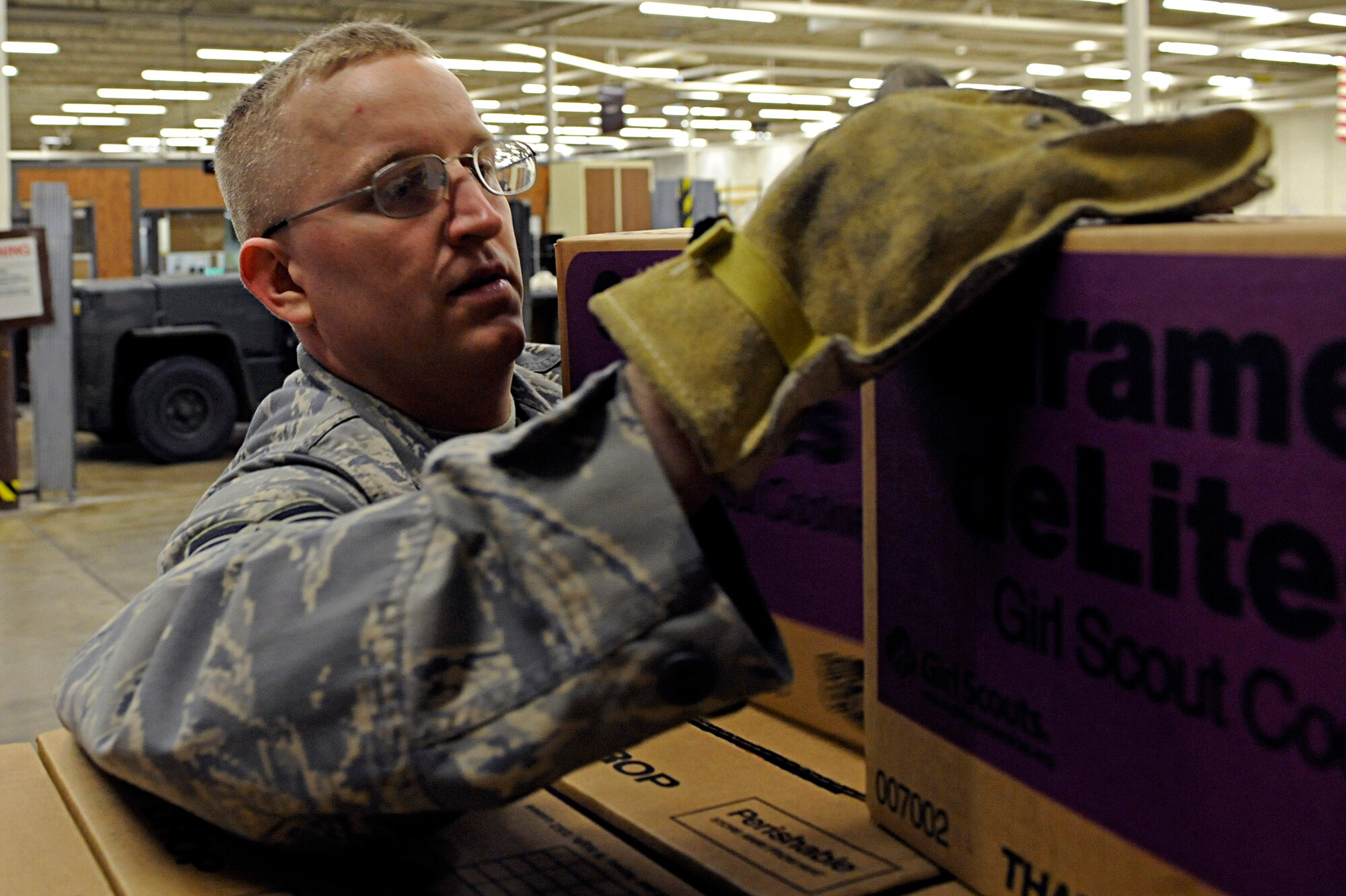 ELLSWORTH AIR FORCE BASE, S.D. -- Staff Sgt. David Teall, 28th Logistics Readiness Squadron central station supervisor, selects boxes of Girl Scout cookies to be placed on a pallet, March 13. Airmen from the 28 LRS organized more than 3,000 cases of Girl Scout cookies for local distribution. (U.S. Air Force photo/Airman 1st Class Matthew Flynn)