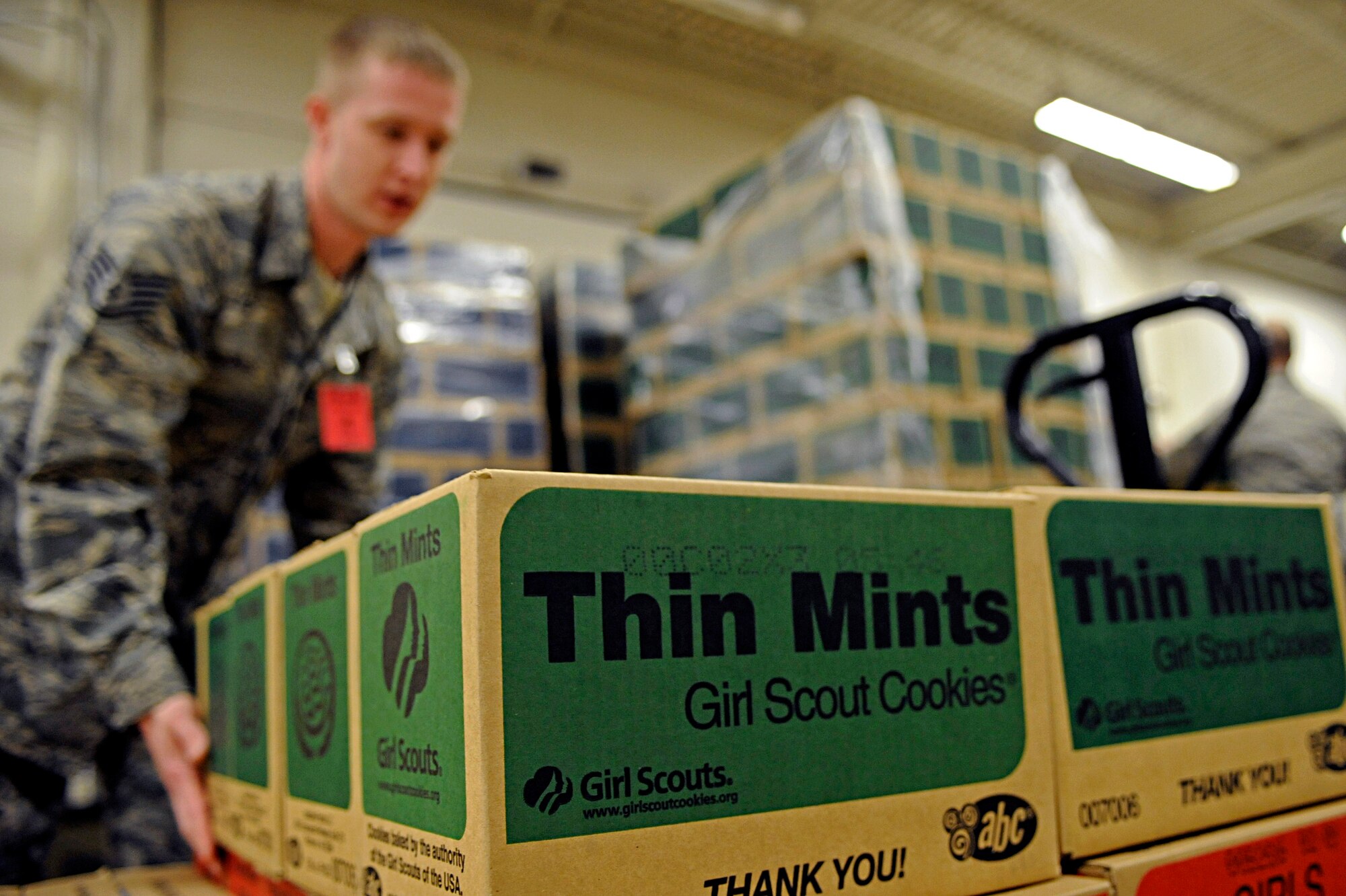 ELLSWORTH AIR FORCE BASE, S.D. -- Staff Sgt. Jonathan Borries, 28th Logistics Readiness Squadron fuel service center supervisor, places boxes of Girl Scout cookies on a pallet, March 13. The 28 LRS have volunteered to organize cookie orders the past five years for the local Girl Scout troops. (U.S. Air Force photo/Airman 1st Class Matthew Flynn)