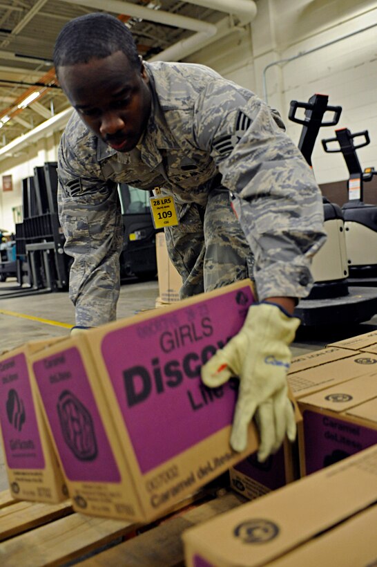 ELLSWORTH AIR FORCE BASE, S.D. -- Senior Airman Preston Winn, 28th Logistics Readiness Squadron receiving journeyman, places boxes of Girl Scout cookies on a pallet, March 13. More than 20 Airmen volunteered to organize the boxes for local Girl Scout troops to distribute. (U.S. Air Force photo/Airman 1st Class Matthew Flynn)