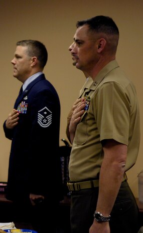 Master Sgt. Timothy Smith, left, Marine Gunnery Sgt. Jamie Nicholson and Marine Capt. Shawn Rickrode, right, recite the Pledge of Allegiance at the Charleston Metro Chamber of Commerce Military/Defense Community benefit March 11. The benefit raised funds for programs such as infrastructure funding, public policy and the military relations community. Military members spoke about the support the chamber offered within the community as well as to deployed members overseas. Sergeant Smith is the 437th Logistics Readiness Squadron first sergeant, and Sergeant Nicholson and Captain Rickrode are Reserve Officers' Training Corps instructors at The Citadel. (U.S. Air Force photo/Airman 1st Class Lauren Main)