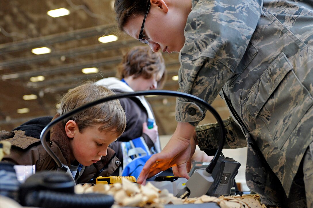 ELLSWORTH AIR FORCE BASE, S.D. -- Senior Airman Carolyn Southards, 28th Civil Engineer Squadron emergency management journeyman, shows a military child how the AHURA first defender chemical identification kit can verify different substances, March 13. The focus of the event was to give families of Airmen a better understanding of what it means to deploy. (U.S. Air Force photo/Airman 1st Class Matthew Flynn)