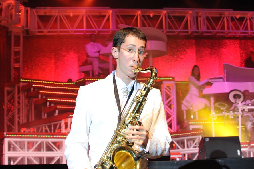 ABILENE, Texas – Air Force Tops in Blue saxophonist Senior Airman Simon Lahn, 100th Comptroller Squadron, Royal Air Force Mildenhall, England, walks off stage while playing his saxophone March 9 at the Abilene Civic Center here. Tops in Blue is an all-active duty Air Force special unit made up of talented amateur performers selected for their entertainment abilities. Each year, thousands compete in base talent contests and the most talented move on to higher levels of competition. The result is an elite group composed of 35 of the most talented vocalists, musicians, dancers, comedians, magicians, and dramatists worldwide. Known as the Air Forces’ Expeditionary Entertainers; the group’s main mission is to perform for military personnel and their families throughout the world. The enormous popularity of the group has also made them America’s goodwill ambassadors around the globe. For more information, logon to the Tops in Blue website at www.topsinblue.com. (U.S Air Force photo/ Airman 1st Class Shannon Hall)