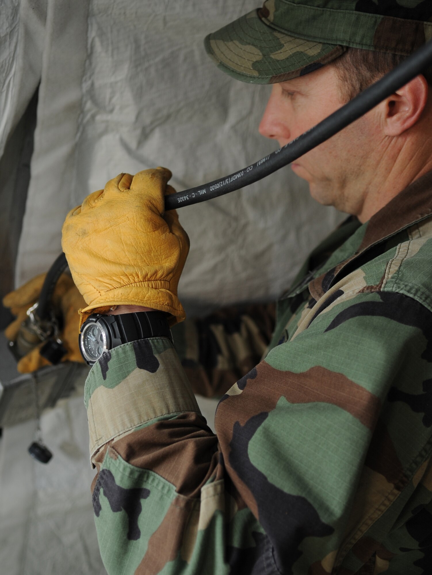U.S. Air Force Lt. Col. Kirk Winger, 86th Aerospace Medicine public health flight commander, connects a power cord for the lights inside of tents during the tent build up portion of the Expeditionary Medical Support (EMEDS) Mobile Course, Ramstein Air Base, Germany, March 15, 2010. The EMEDS course teaches and evaluates corps specific field situations as well as offers updates in Air Force Medical Service concept of operations and doctrine.  It also teaches setup and packing out of a field EMEDS compound, deployed operations, field medical, nursing and operational support equipment proficiency, field exercises to both emphasize and evaluate learning of concepts taught. (U.S. Air Force photo by Airman 1st Class Caleb Pierce)