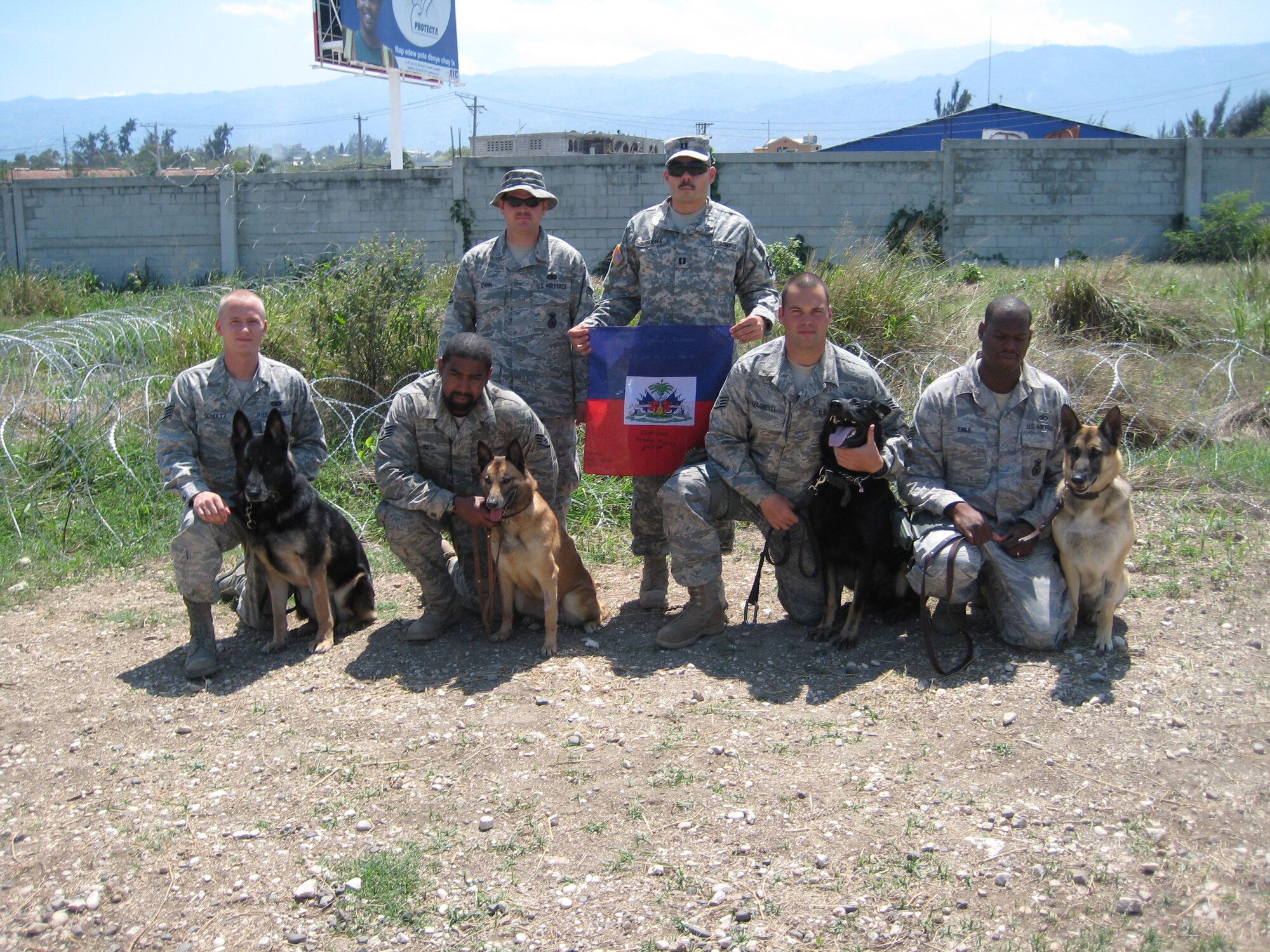 PORT-AU-PRINCE, Haiti -- Military working dog handlers from the 823rd Expeditionary Security Forces Squadron pose with their canine partners near Port-au-Prince, Haiti, March 7. The MWD teams conducted more than 500 hours of foot patrols as part of their mission in providing security at the Toussaint L'Ouverture International Airport after a devastating earthquake hit Haiti Jan. 12. (Contributed photo)