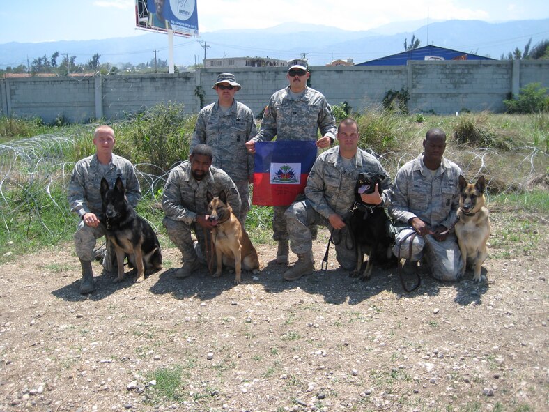 PORT-AU-PRINCE, Haiti -- Military working dog handlers from the 823rd Expeditionary Security Forces Squadron pose with their canine partners near Port-au-Prince, Haiti, March 7. The MWD teams conducted more than 500 hours of foot patrols as part of their mission in providing security at the Toussaint L'Ouverture International Airport after a devastating earthquake hit Haiti Jan. 12. (Contributed photo)