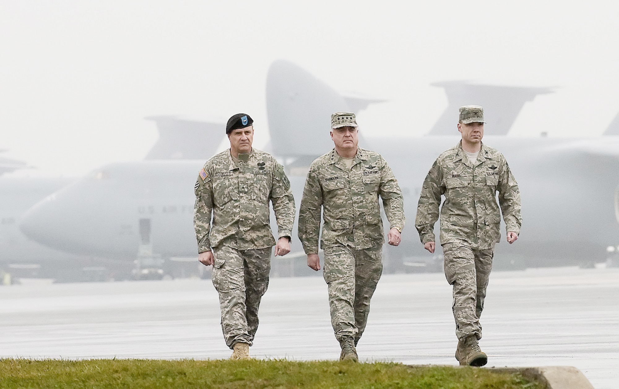 Brig. Gen. Kenneth Roberts (from left), special assistant for the director of the Army National Guard; Gen. Carrol H. "Howie" Chandler, vice chief of staff of the Air Force; and Col. Manson Morris, 436th Airlift Wing commander, return from the dignified transfer on the flight line at Dover Air Force Base, Del., March 12, 2010, of two fallen servicemembers of Operation Enduring. A solemn dignified transfer of a fallen member is conducted upon arrival at the base from the aircraft to a transfer vehicle to honor those who died in the theater of operation while serving their country. The member is then transferred to the Air Force Mortuary Affairs Operations Center. General Chandler and his wife, Eva-Marie, toured center, participated in a dignified transfer and met family members of the fallen. (U.S. Air Force photo/Jason Minto)