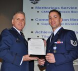 TRAVIS AIR FORCE BASE, Calif. -- At the 349th Air Mobility Wing commander’s call Mar. 7, 2010, six wing Airmen were recognized with medals for exceptional service. They are pictured here at attention prior to their presentations. From the left: Wing Commander, Col. John Flournoy; Command Chief Master Sgt. Kathleen Buckner, received the Air Force Meritorious Service Medal, second oak leaf cluster; CMSgt. Glenn Orfitelli, received the MSM, first OLC; Capt. Rachel Alvarez Montiel received the Air Force Commendation Medal; Tech. Sgt. Glen Miller received the Air Force Achievement Medal, fifth OLC; TSgt. Timothy Stotenburg received the AFAM, first OLC and TSgt. Jonathan Caraballo received the AFAM. (U.S. Air Force photo/Senior Master Sgt. Ellen Hatfield) 