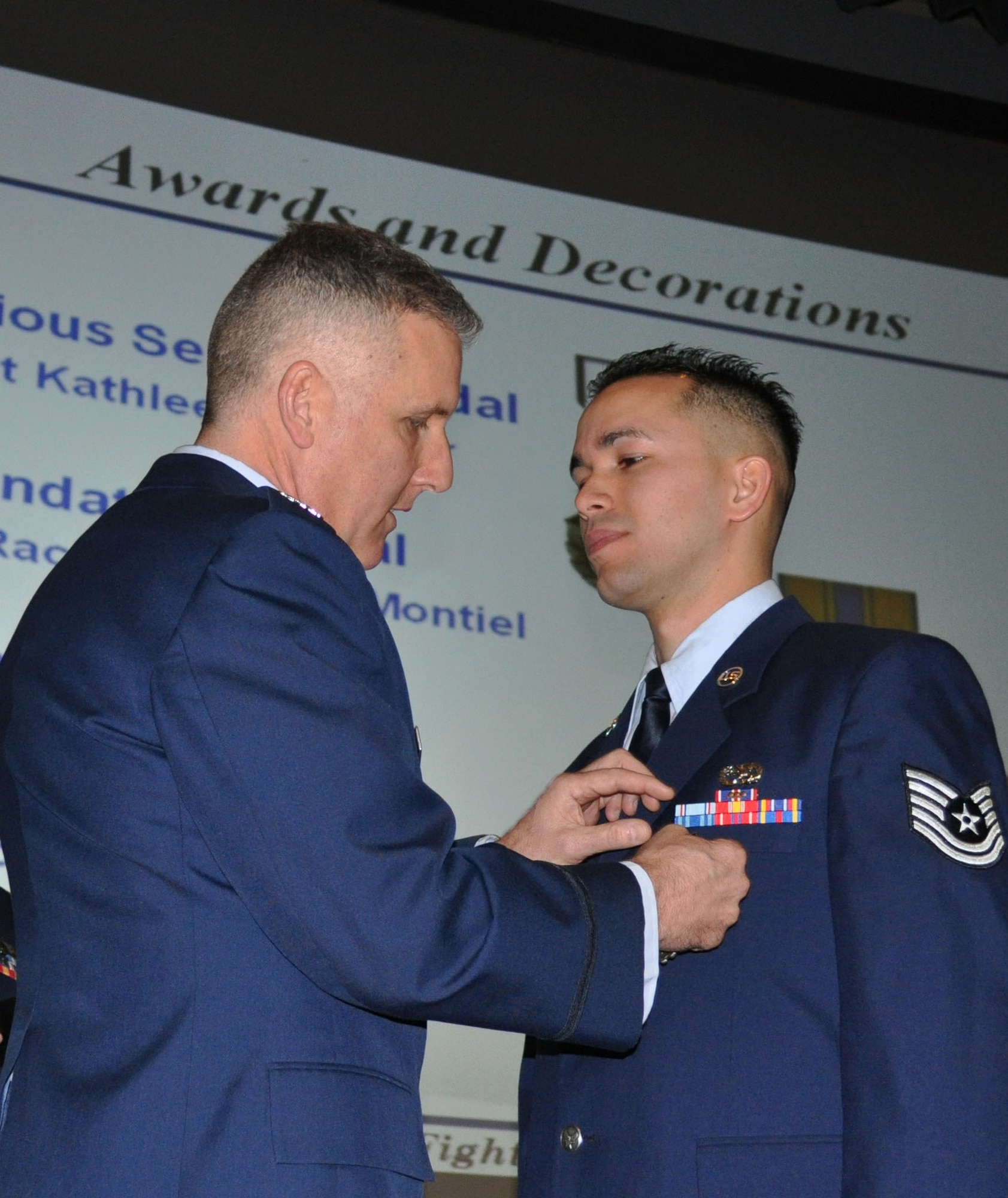 TRAVIS AIR FORCE BASE, Calif. -- At the 349th Air Mobility Wing commander’s call Mar. 7, 2010, six wing Airmen were recognized with medals for exceptional service. They are pictured here at attention prior to their presentations. From the left: Wing Commander, Col. John Flournoy; Command Chief Master Sgt. Kathleen Buckner, received the Air Force Meritorious Service Medal, second oak leaf cluster; CMSgt. Glenn Orfitelli, received the MSM, first OLC; Capt. Rachel Alvarez Montiel received the Air Force Commendation Medal; Tech. Sgt. Glen Miller received the Air Force Achievement Medal, fifth OLC; TSgt. Timothy Stotenburg received the AFAM, first OLC and TSgt. Jonathan Caraballo received the AFAM. (U.S. Air Force photo/Senior Master Sgt. Ellen Hatfield) 