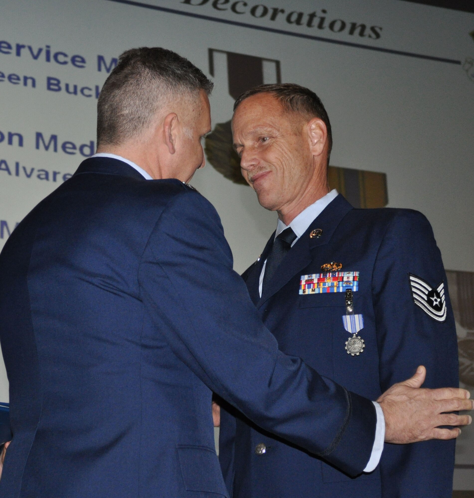 TRAVIS AIR FORCE BASE, Calif. -- At the 349th Air Mobility Wing commander’s call Mar. 7, 2010, six wing Airmen were recognized with medals for exceptional service. They are pictured here at attention prior to their presentations. From the left: Wing Commander, Col. John Flournoy; Command Chief Master Sgt. Kathleen Buckner, received the Air Force Meritorious Service Medal, second oak leaf cluster; CMSgt. Glenn Orfitelli, received the MSM, first OLC; Capt. Rachel Alvarez Montiel received the Air Force Commendation Medal; Tech. Sgt. Glen Miller received the Air Force Achievement Medal, fifth OLC; TSgt. Timothy Stotenburg received the AFAM, first OLC and TSgt. Jonathan Caraballo received the AFAM. (U.S. Air Force photo/Senior Master Sgt. Ellen Hatfield) 