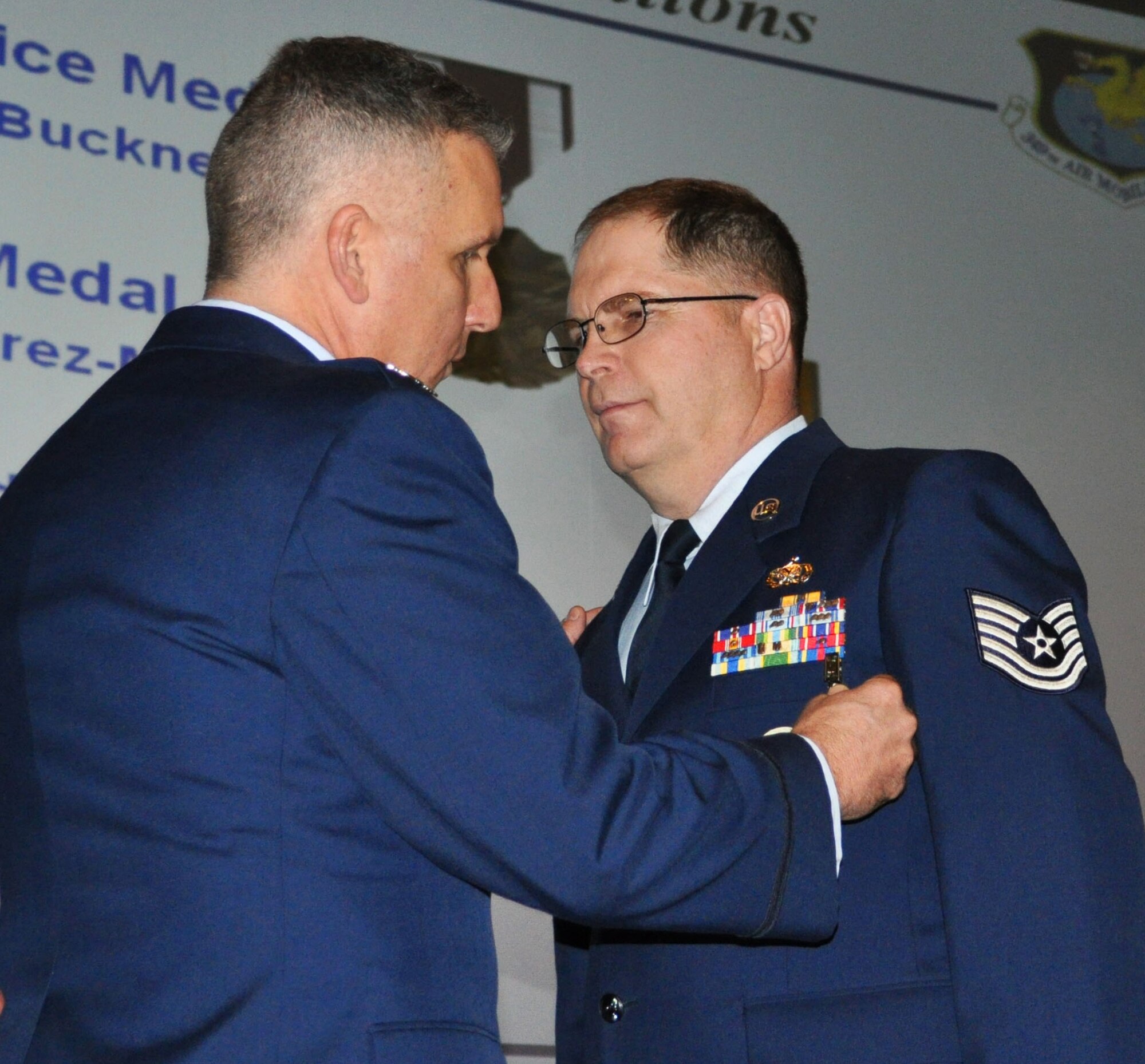 TRAVIS AIR FORCE BASE, Calif. -- At the 349th Air Mobility Wing commander’s call Mar. 7, 2010, six wing Airmen were recognized with medals for exceptional service. They are pictured here at attention prior to their presentations. From the left: Wing Commander, Col. John Flournoy; Command Chief Master Sgt. Kathleen Buckner, received the Air Force Meritorious Service Medal, second oak leaf cluster; CMSgt. Glenn Orfitelli, received the MSM, first OLC; Capt. Rachel Alvarez Montiel received the Air Force Commendation Medal; Tech. Sgt. Glen Miller received the Air Force Achievement Medal, fifth OLC; TSgt. Timothy Stotenburg received the AFAM, first OLC and TSgt. Jonathan Caraballo received the AFAM. (U.S. Air Force photo/Senior Master Sgt. Ellen Hatfield) 