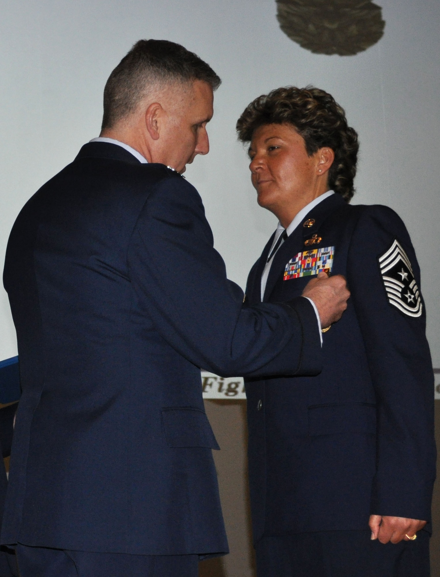 TRAVIS AIR FORCE BASE, Calif. -- At the 349th Air Mobility Wing commander’s call Mar. 7, 2010, six wing Airmen were recognized with medals for exceptional service. They are pictured here at attention prior to their presentations. From the left: Wing Commander, Col. John Flournoy; Command Chief Master Sgt. Kathleen Buckner, received the Air Force Meritorious Service Medal, second oak leaf cluster; CMSgt. Glenn Orfitelli, received the MSM, first OLC; Capt. Rachel Alvarez Montiel received the Air Force Commendation Medal; Tech. Sgt. Glen Miller received the Air Force Achievement Medal, fifth OLC; TSgt. Timothy Stotenburg received the AFAM, first OLC and TSgt. Jonathan Caraballo received the AFAM. (U.S. Air Force photo/Senior Master Sgt. Ellen Hatfield) 