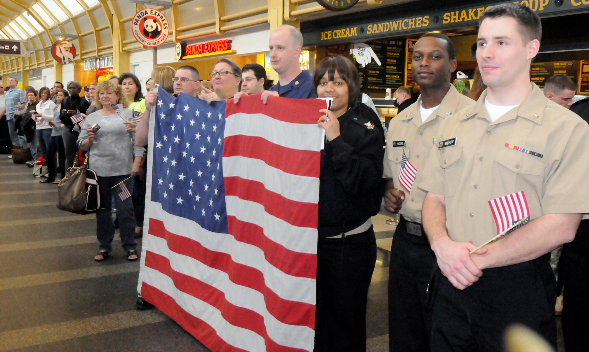A crowd of military and civilian supporters gathers to welcome World War II Honor Flight veterans to Ronald Reagan Washington National Airport March 10. More than 200 active duty military members gathered to greet the 256 incoming veterans.  Since May 2005, Honor Flight Network has transported more than 36,000 World War II, Korea and Viet Nam veterans to Washington, D.C., for a one-day trip that includes sightseeing at all of the  memorials built in honor of the veterans. (U.S. Air Force photo by Airman 1st Class Susan Moreno)