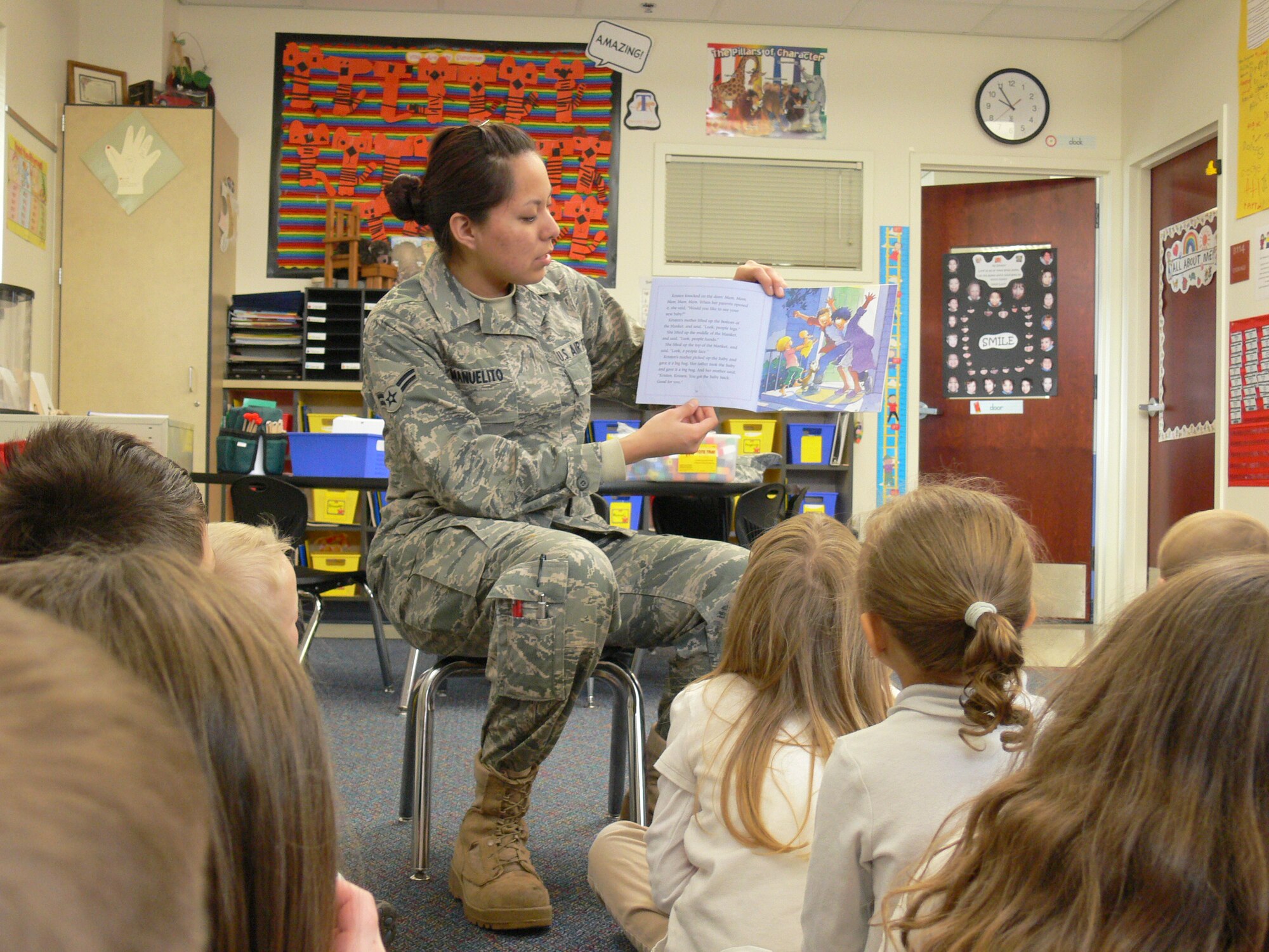 Airman 1st Class Shelby Manuelito, 21st Force Support Squadron, reads to kindergartners March 8, in Tina Ferguson’s class at Christa McAuliffe Elementary School in Colorado Springs School District 11. Peterson Air Force Base recently launched an “Adopt A School” program where Airmen and civilians can volunteer in area schools. District 11 school officials say there are endless volunteer opportunities for Airmen to be mentors, readers, lunch buddies and more. For more information about the program call Lisa Ballard, Peterson school liaison, at 556-7596. (U.S. Air Force photo/Monica Mendoza)  